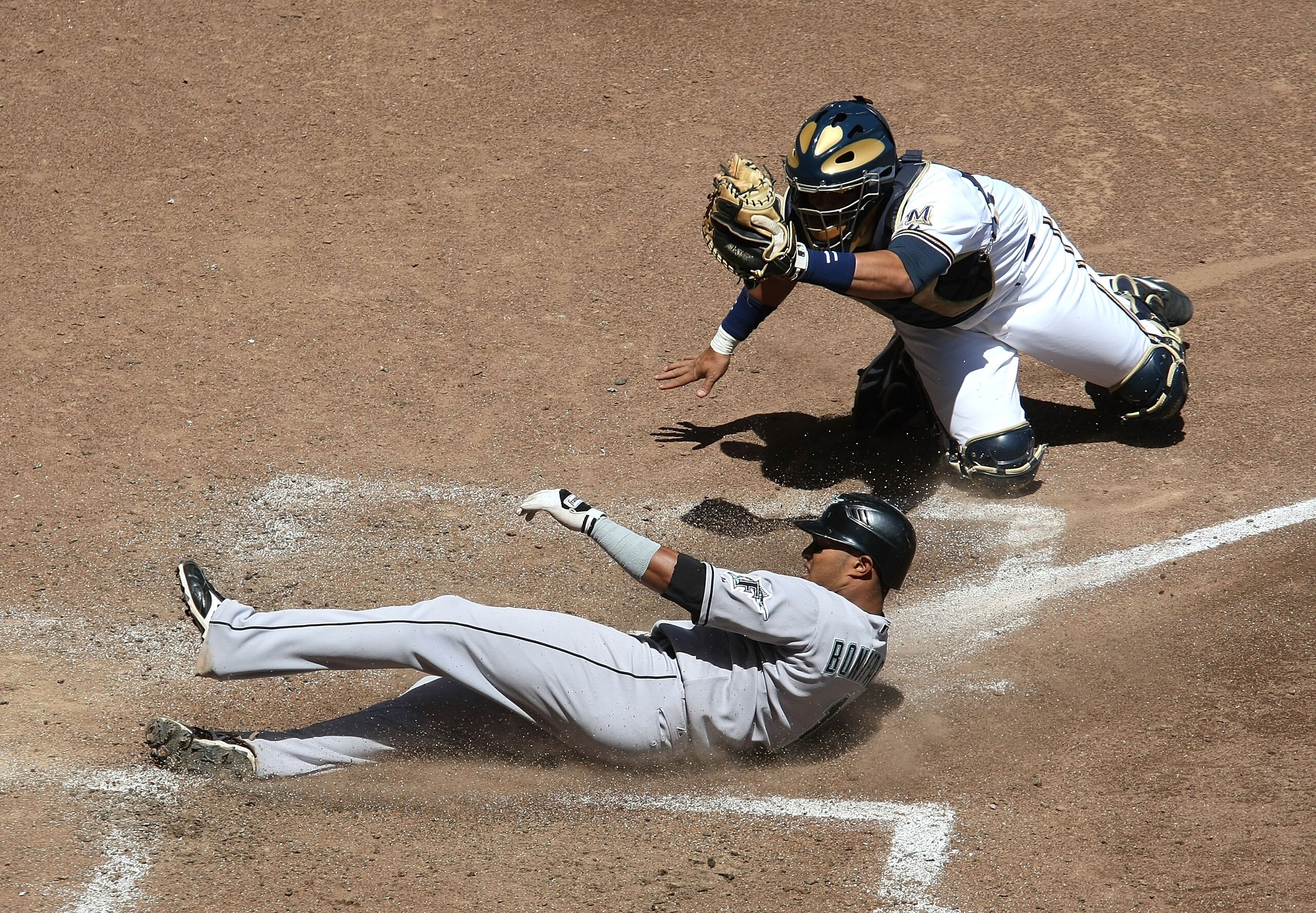 MILWAUKEE - MAY 14: Mike Rivera #11 of the Milwaukee Brewers shows the ball to the umpire after tagging out Emilio Bonifacio #1 of the Florida Marlins in the 5th inning on May 14, 2009 at Miller Park in Milwaukee, Wisconsin. The Brewers defeated the Marli