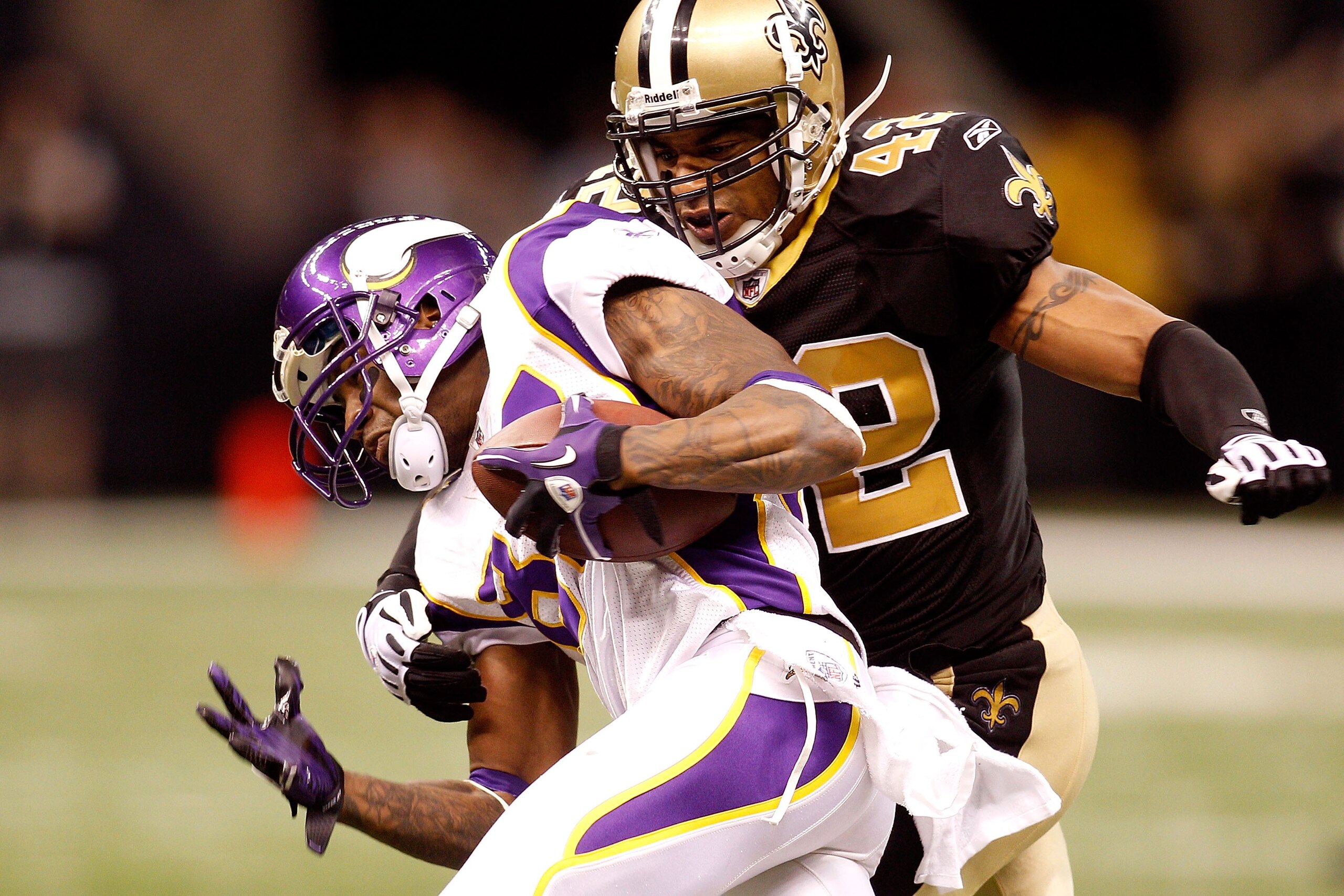 NEW ORLEANS - JANUARY 24:  Darren Sharper #42 of the New Orleans Saints attempts to tackle Bernard Berrian #87 of the Minnesota Vikings during the NFC Championship Game at the Louisiana Superdome on January 24, 2010 in New Orleans, Louisiana. The Saints w