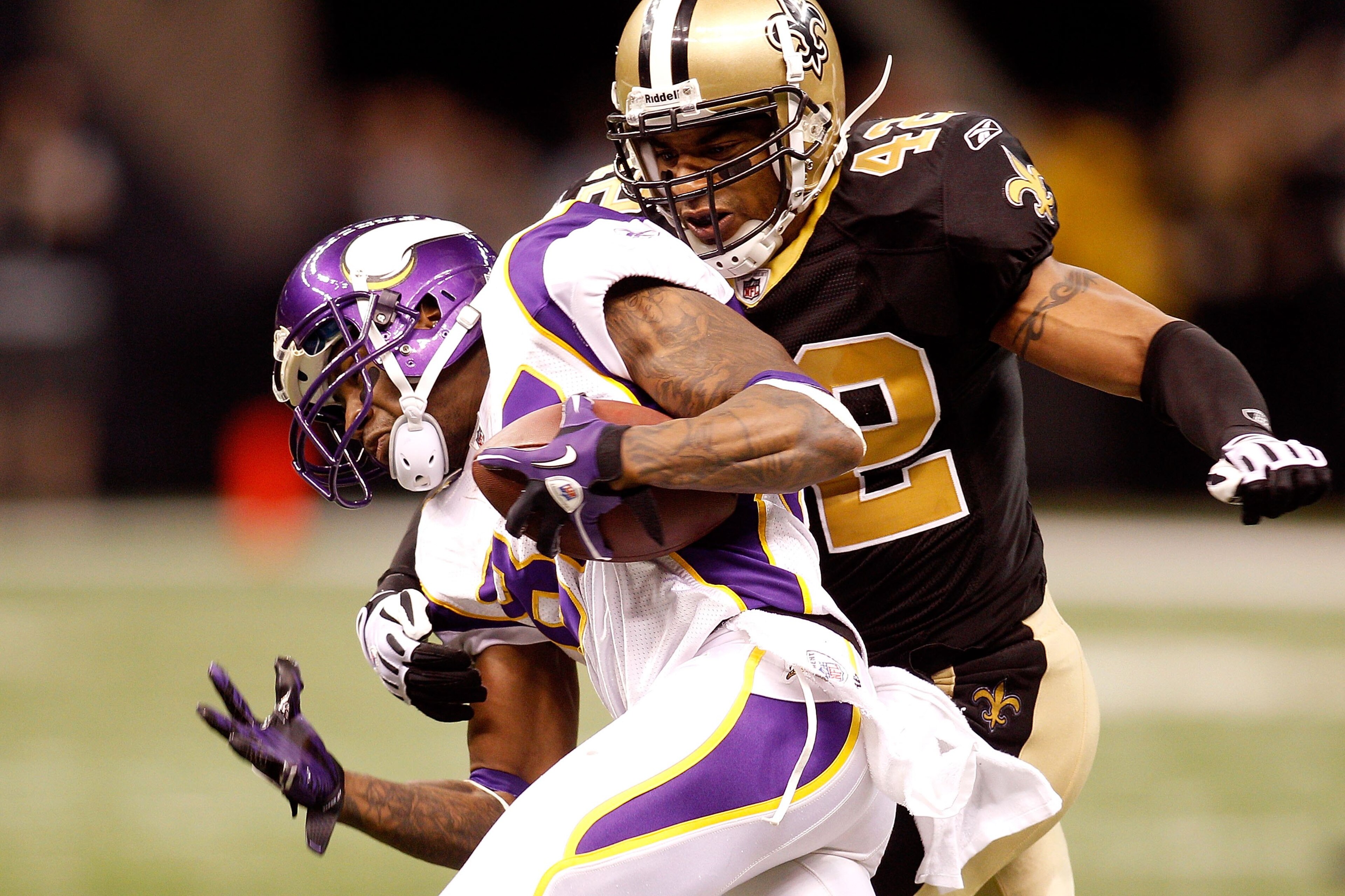 NEW ORLEANS - JANUARY 24:  Darren Sharper #42 of the New Orleans Saints attempts to tackle Bernard Berrian #87 of the Minnesota Vikings during the NFC Championship Game at the Louisiana Superdome on January 24, 2010 in New Orleans, Louisiana. The Saints w