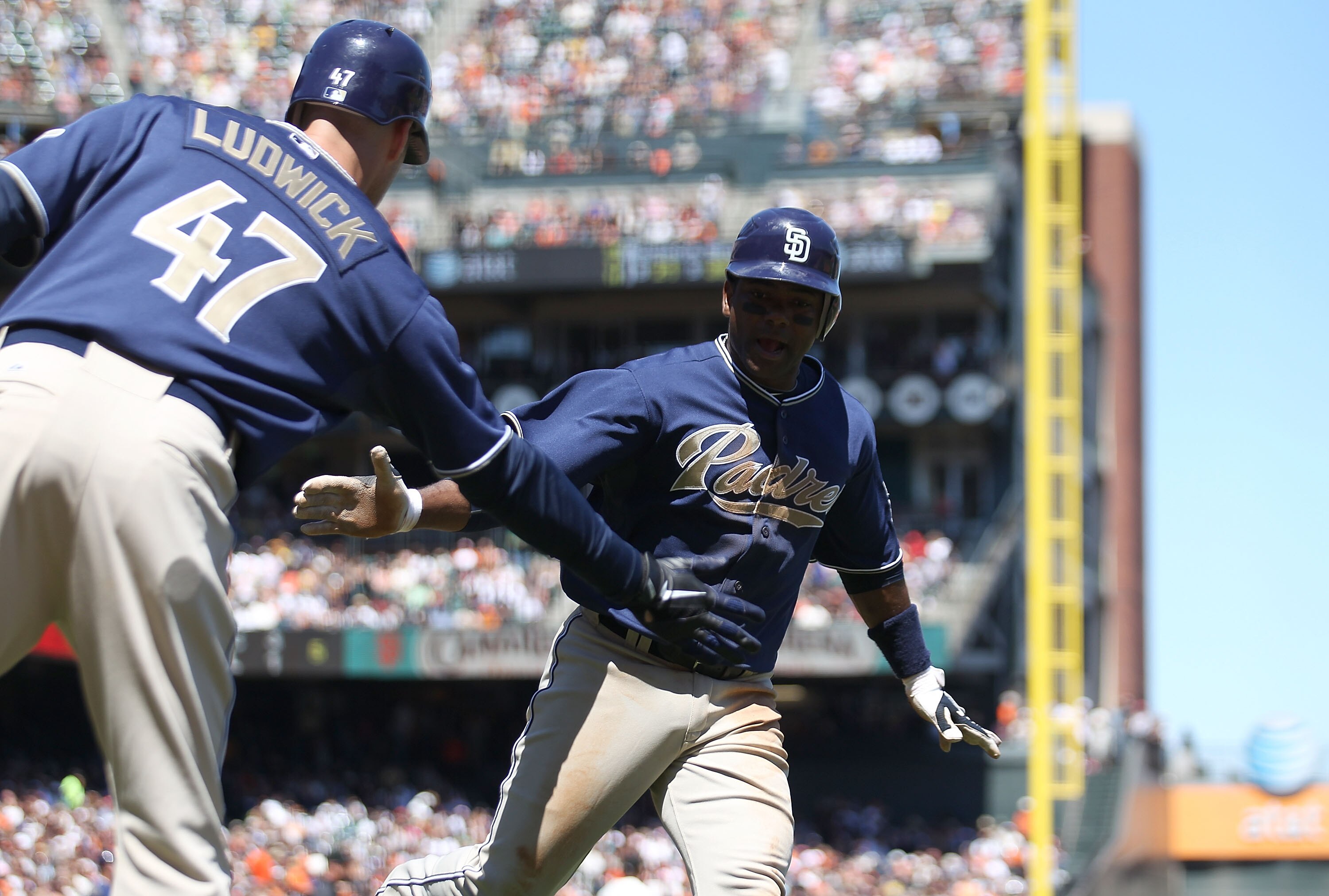 SAN FRANCISCO - AUGUST 14:  Miguel Tejada #10  of the San Diego Padres celebrates with Ryan Ludwick #47 after scoring on a double by Adrian Gonzalez against the San Francisco Giants in the fifth inning during an MLB game at AT&T Park on August 14, 2010 in