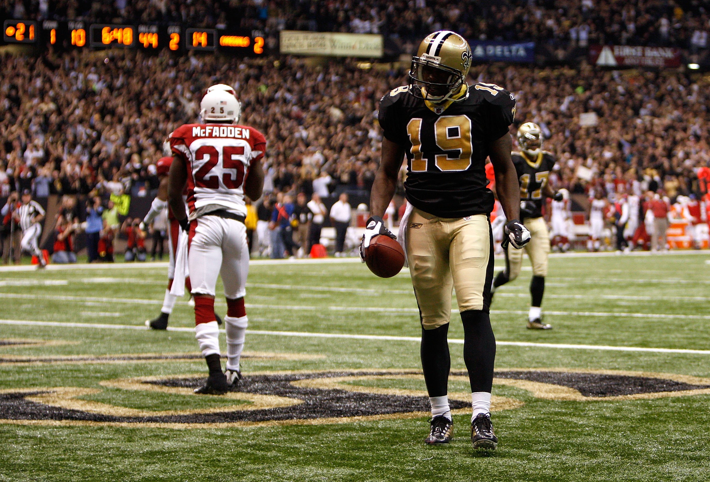 NEW ORLEANS - JANUARY 16:  Devery Henderson #19 of the New Orleans Saints reacts after he scored on a 44-yard touchdown reception in the second quarter against Bryant McFadden #25 of the Arizona Cardinals during the NFC Divisional Playoff Game at Louisana