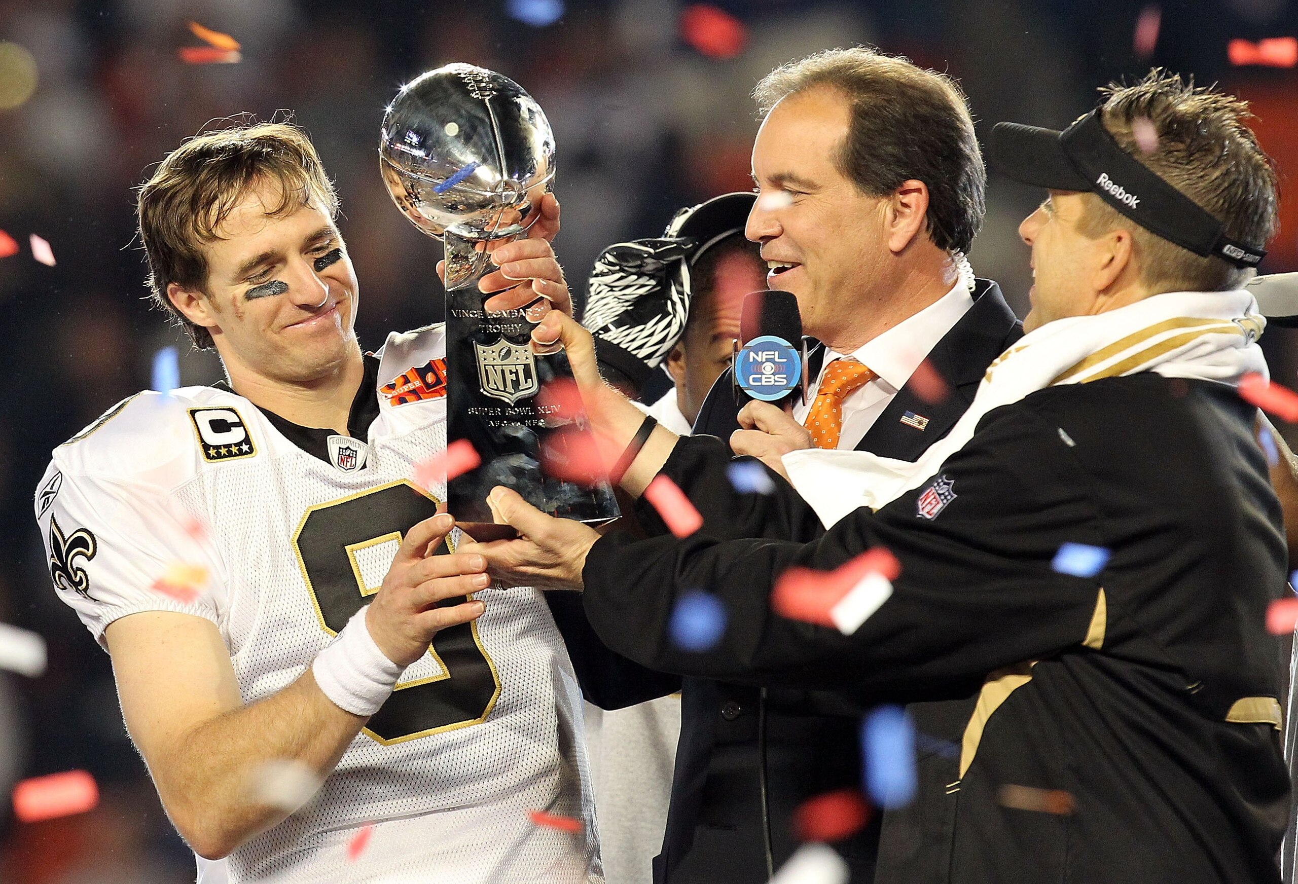 MIAMI GARDENS, FL - FEBRUARY 07: Head coach Sean Payton of the New Orleans Saints passes quarterback Drew Brees #9 the Vince Lombardi trophy after defeating the Indianapolis Colts during Super Bowl XLIV on February 7, 2010 at Sun Life Stadium in Miami Ga MIAMI GARDENS, FL - FEBRUARY 07: Head coach Sean Payton of the New Orleans Saints passes quarterback Drew Brees #9 the Vince Lombardi trophy after defeating the Indianapolis Colts during Super Bowl XLIV on February 7, 2010 at Sun Life Stadium in Miami Ga