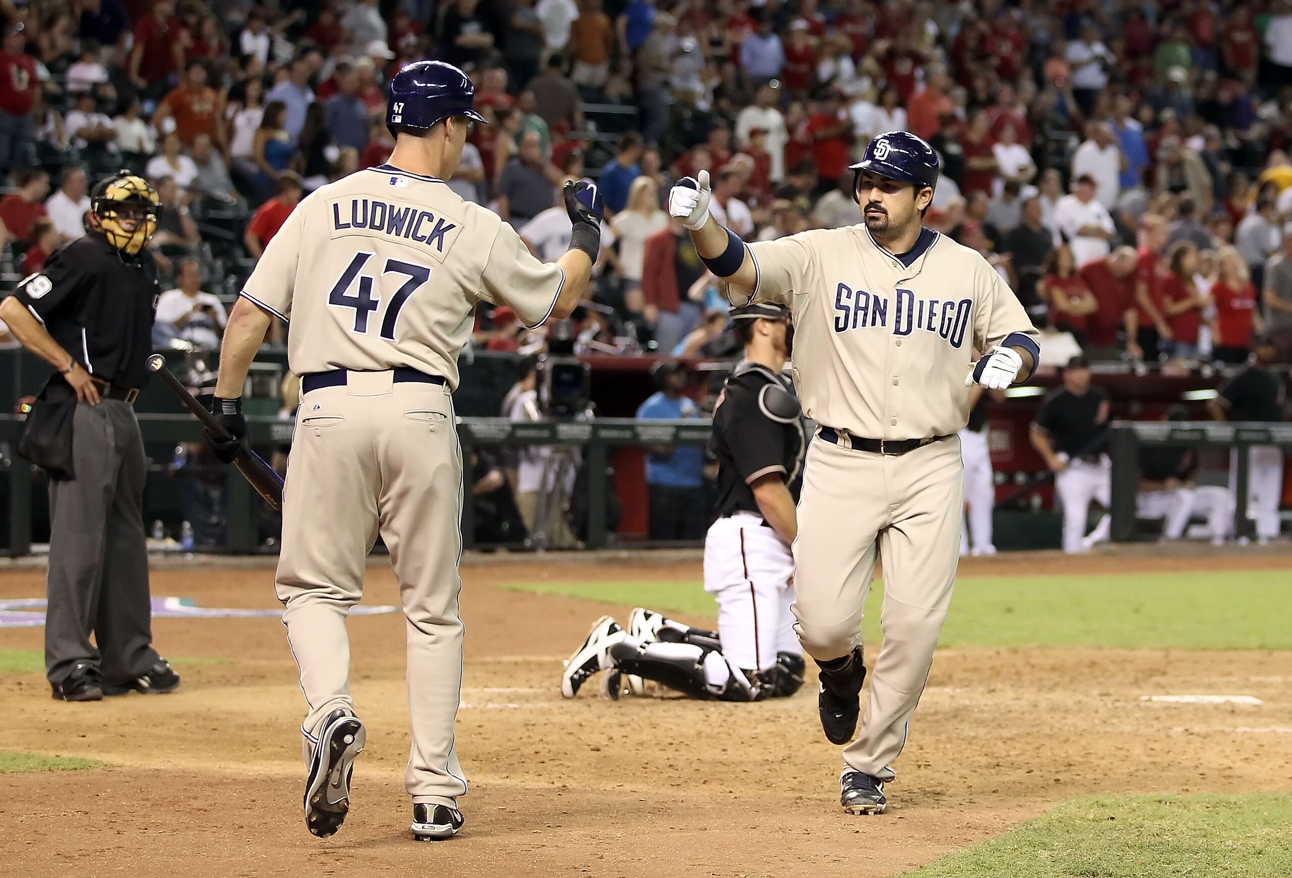 PHOENIX - AUGUST 07:  Adrian Gonzalez #23 of the San Diego Padres celebrates with teammate Ryan Ludwick #47 after Gonzalez hit a solo home run against the Arizona Diamondbacks during the ninth inning of the Major League Baseball game at Chase Field on Aug