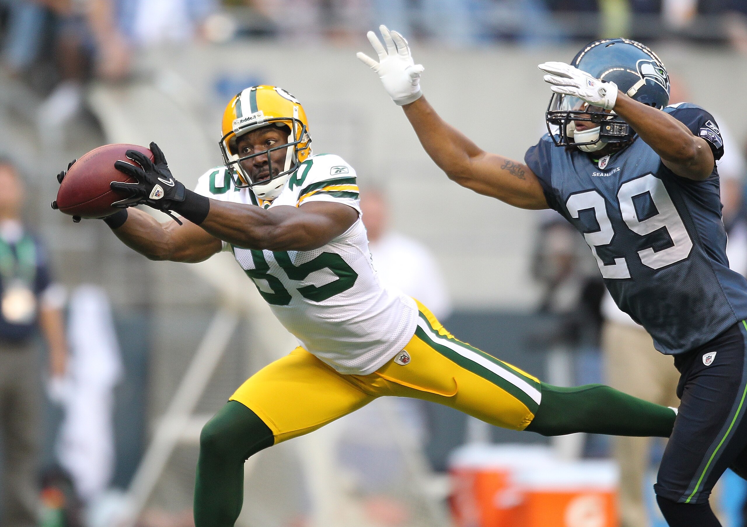 SEATTLE - AUGUST 21:  Wide receiver Greg Jennings #85 of the Green Bay Packers makes a catch during the preseason game against Earl Thomas #29 of the Seattle Seahawks at Qwest Field on August 21, 2010 in Seattle, Washington. (Photo by Otto Greule Jr/Getty