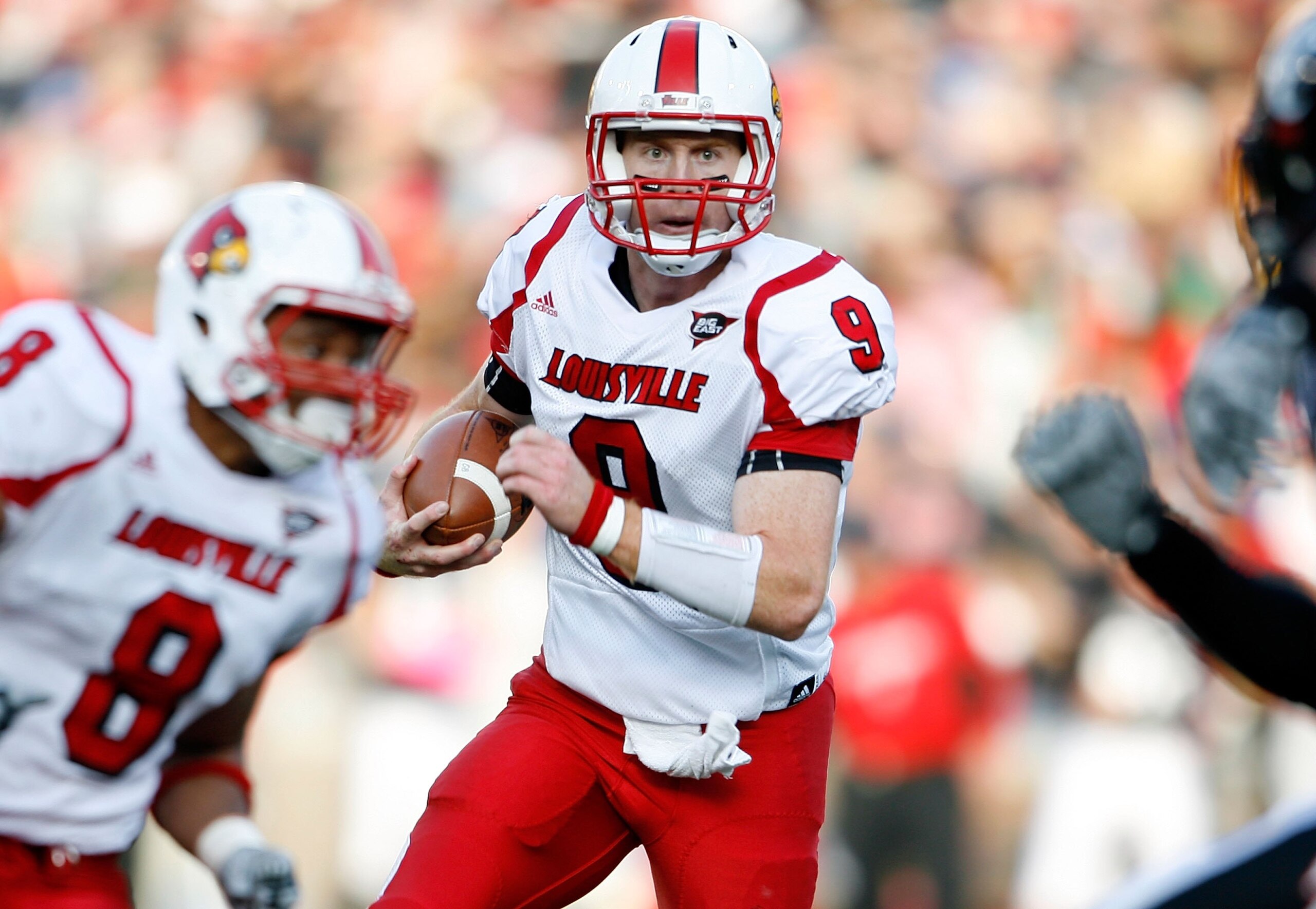 CINCINNATI - OCTOBER 24:  Adam Froman #9 of the Louisville Cardinals runs with the ball during the Big East Conference game against the Cincinnati Bearcats at Nippert Stadium on October 24, 2009 in Cincinnati, Ohio.  (Photo by Andy Lyons/Getty Images)