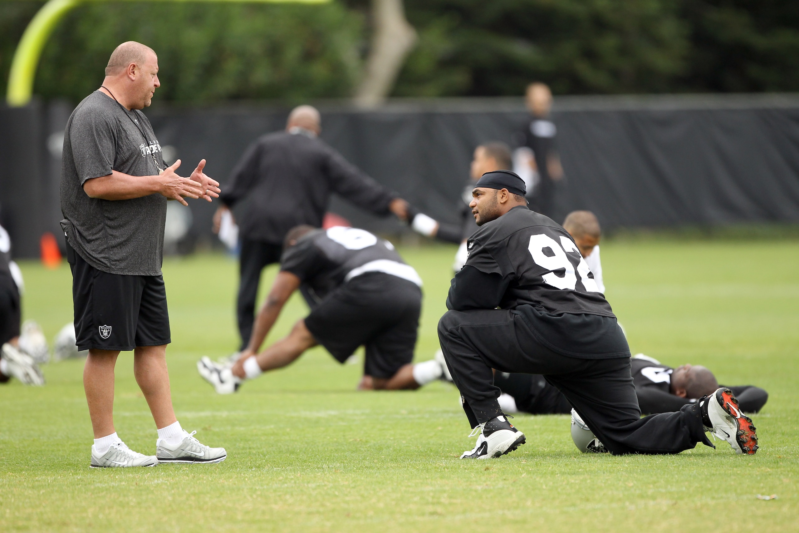 NAPA, CA - AUGUST 01:  Head coach Tom Cable of the Oakland Raiders talks to Richard Seymour #92 during the Raiders training camp at their Napa Valley Training Complex on August 1, 2010 in Napa, California.  (Photo by Ezra Shaw/Getty Images)