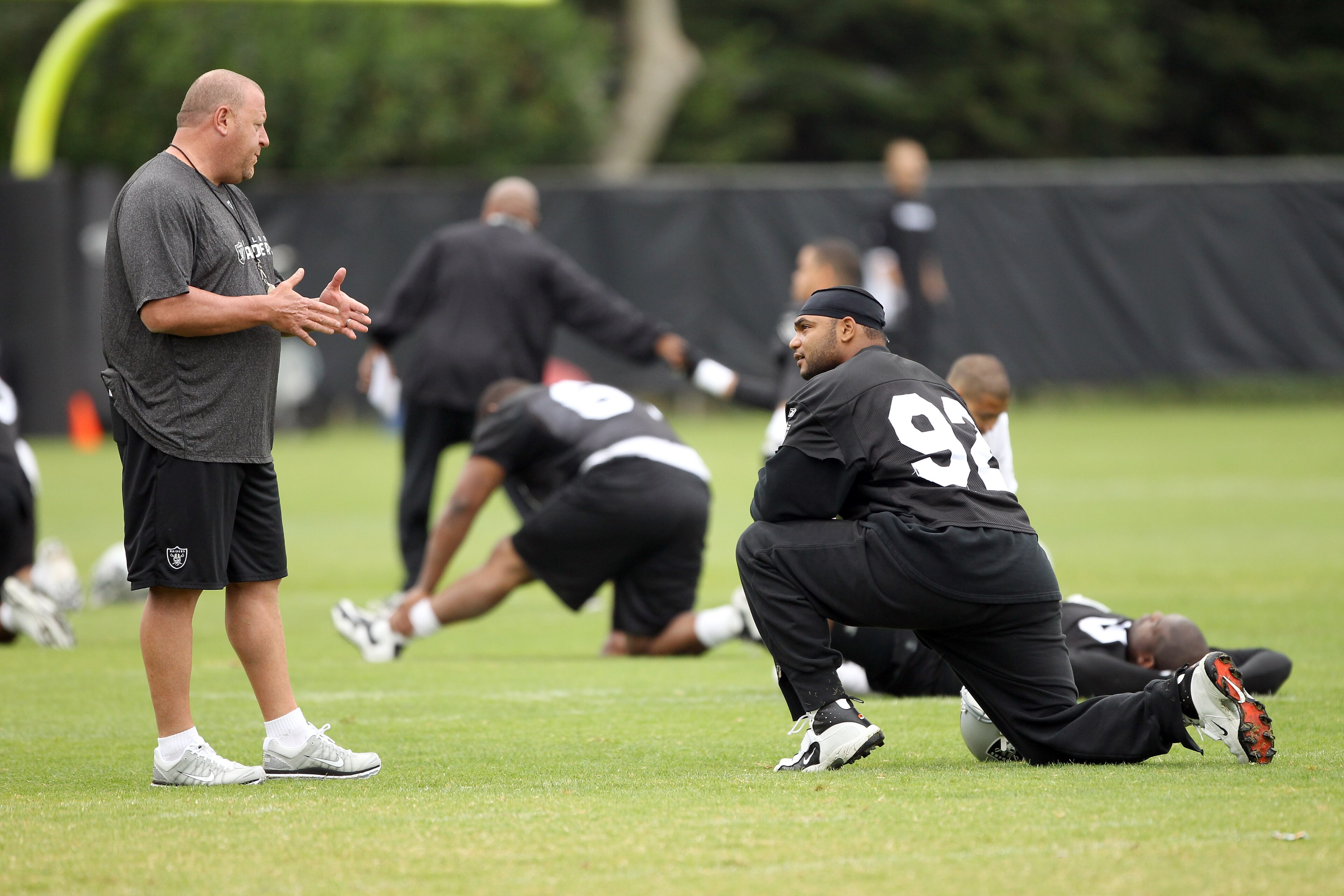 NAPA, CA - AUGUST 01:  Head coach Tom Cable of the Oakland Raiders talks to Richard Seymour #92 during the Raiders training camp at their Napa Valley Training Complex on August 1, 2010 in Napa, California.  (Photo by Ezra Shaw/Getty Images)