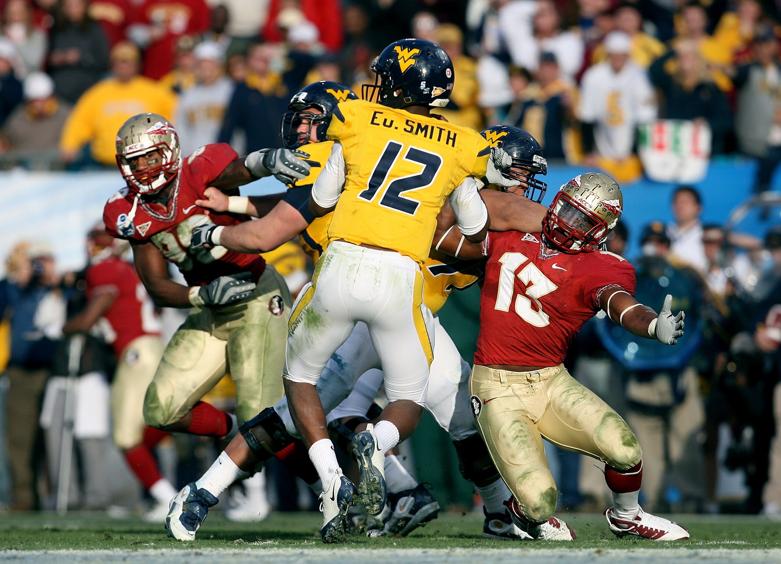 JACKSONVILLE, FL - JANUARY 01:  Linebacker Nigel Bradham #13 of the Florida State Seminoles tries to get to quarterback Geno Smith #12 of the West Virginia Mountaineers during the Konica Minolta Gator Bowl on January 1, 2010 at Jacksonville Municipal Stad