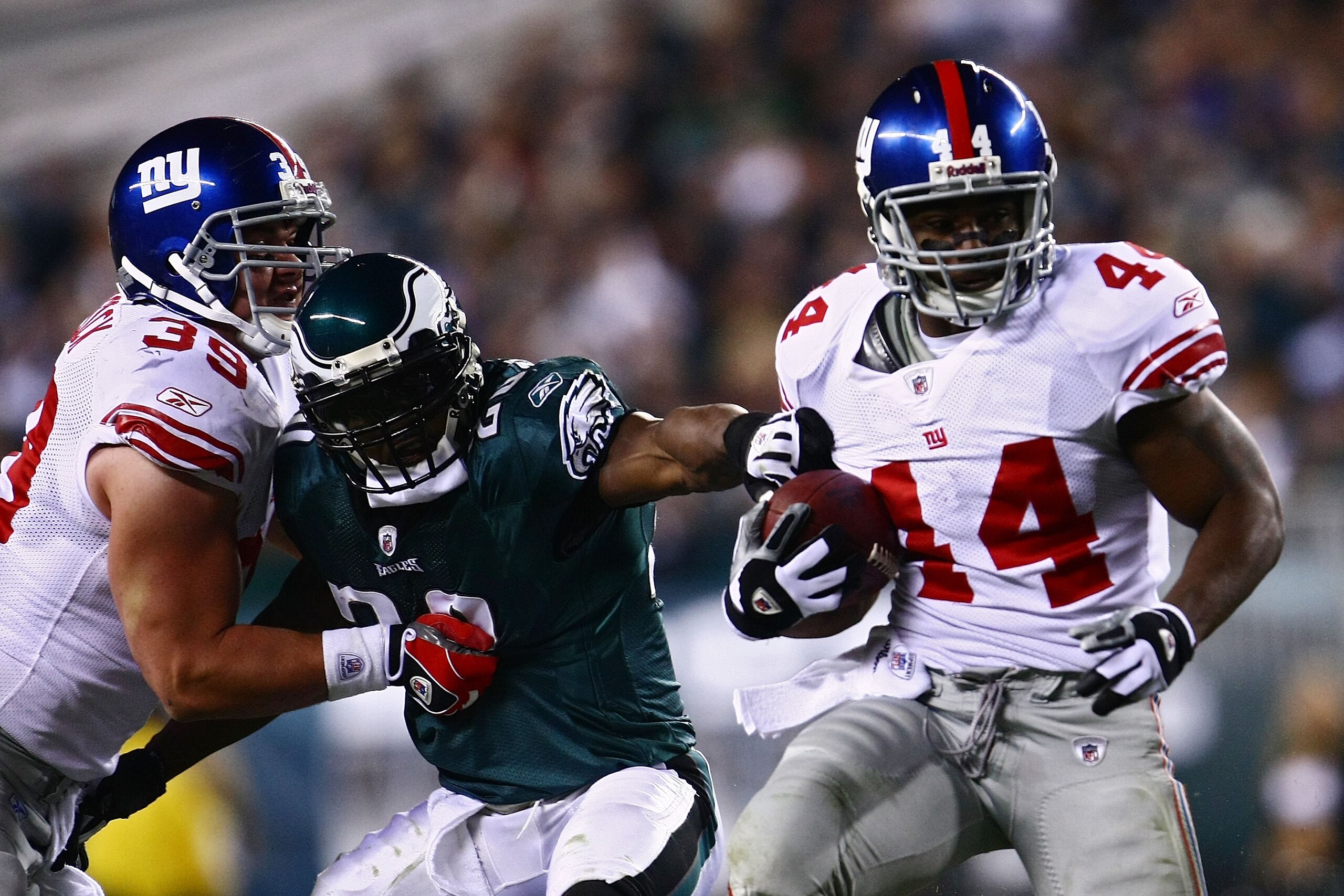PHILADELPHIA - NOVEMBER 09:  Ahmad Bradshaw #44 of the New York Giants runs the ball against Brian Dawkins #20 of the Philadelphia Eagles as Madison Hedgecock #39 blocks at Lincoln Financial Field on November 9, 2008 in Philadelphia, Pennsylvania.  (Photo