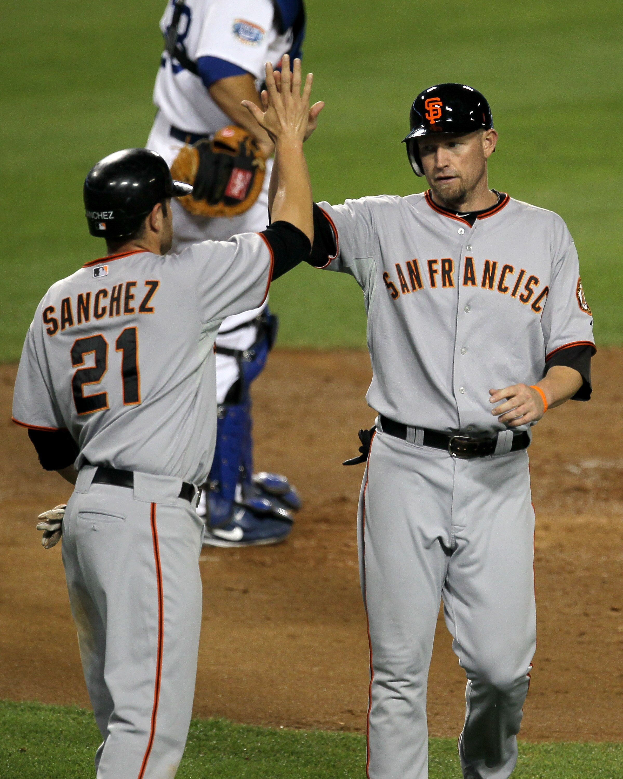 LOS ANGELES - SEPTEMBER 3:  Aubrey Huff #17 and Freddy Sanchez #21 of the San Francisco Giants celebrate after they score on Buster Posey's fourth inning single against the Los Angeles Dodgers on September 3, 2010 at Dodger Stadium in Los Angeles, Califor