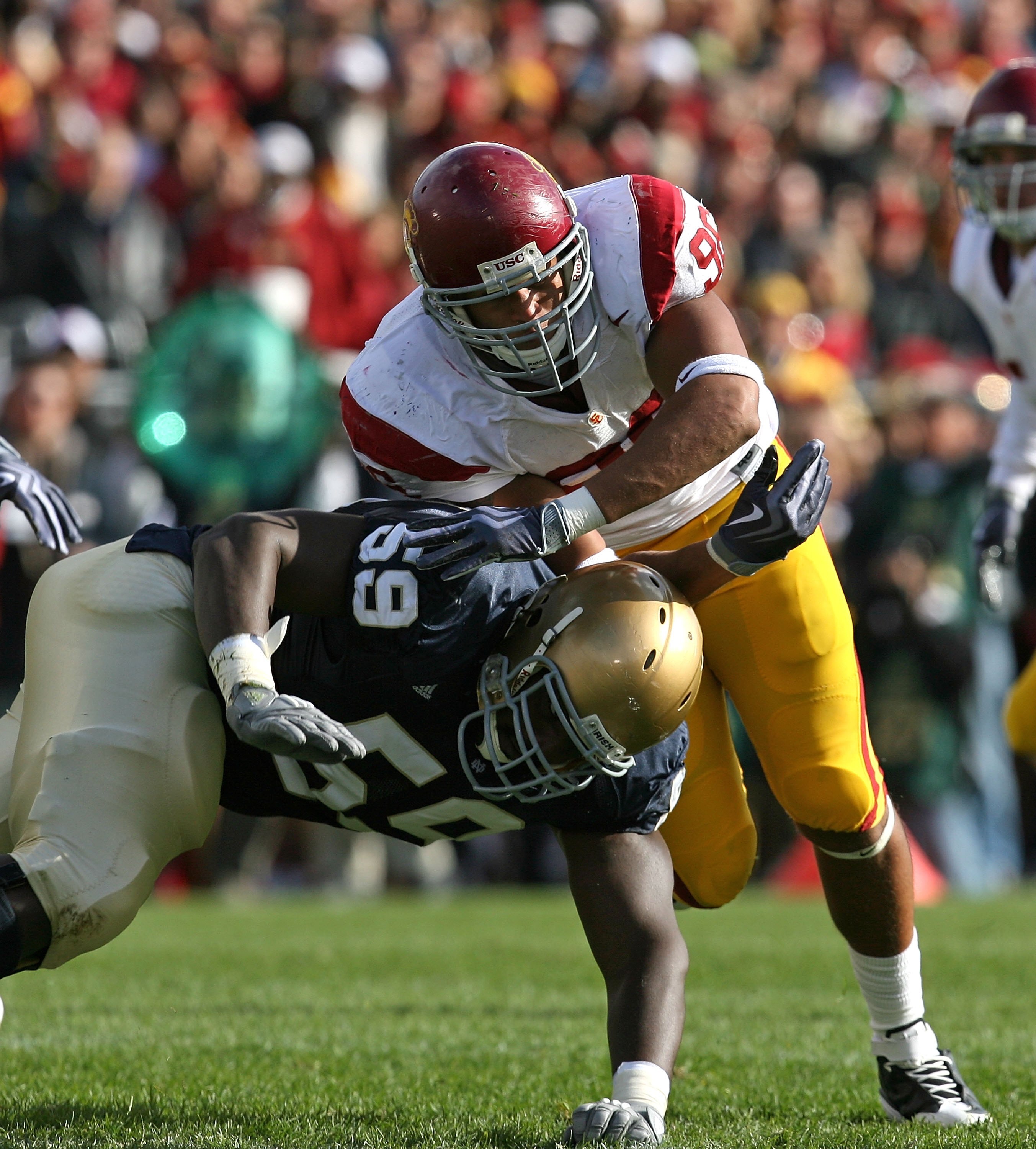 SOUTH BEND, IN - OCTOBER 17: Chris Stewart #59 of the Notre Dame Fighting Irish drops low to block Wes Horton #96 of the USC Trojans at Notre Dame Stadium on October 17, 2009 in South Bend, Indiana. USC defeated Notre Dame 34-27. (Photo by Jonathan Daniel