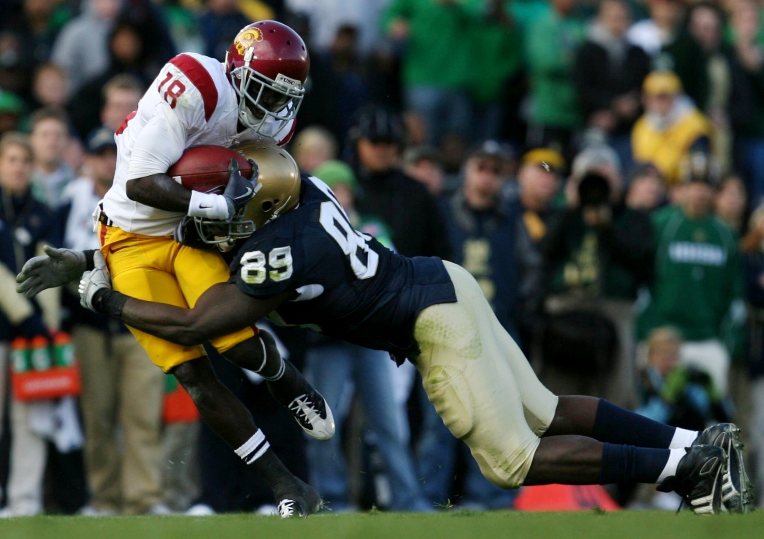 SOUTH BEND, IN - OCTOBER 17: Defensive end Kapron Lewis-Moore #89 of the Notre Dame Fighting Irish tackles  wide receiver Damian Williams #18 of the USC Trojans in the second quarter of the game at Notre Dame Stadium on October 17, 2009 in South Bend, Ind