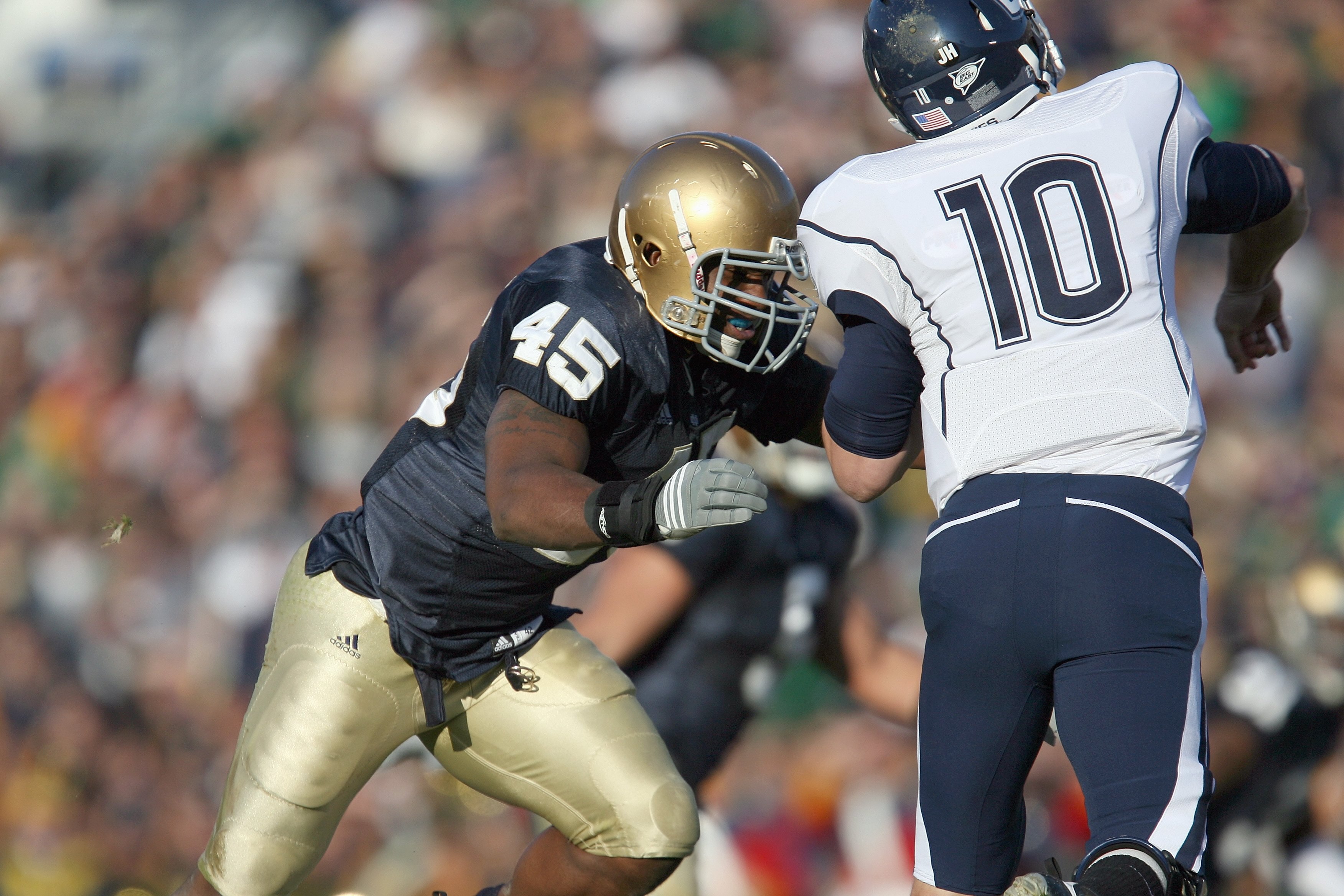 SOUTH BEND, IN - NOVEMBER 21: Darius Fleming #45 of the Notre Dame Fighting Irish moves to sacke quarterback Zach Frazer #10 of the Univeristy of Connecticut Huskies at Notre Dame Stadium on November 21, 2009 in South Bend, Indiana. (Photo by Jonathan Dan