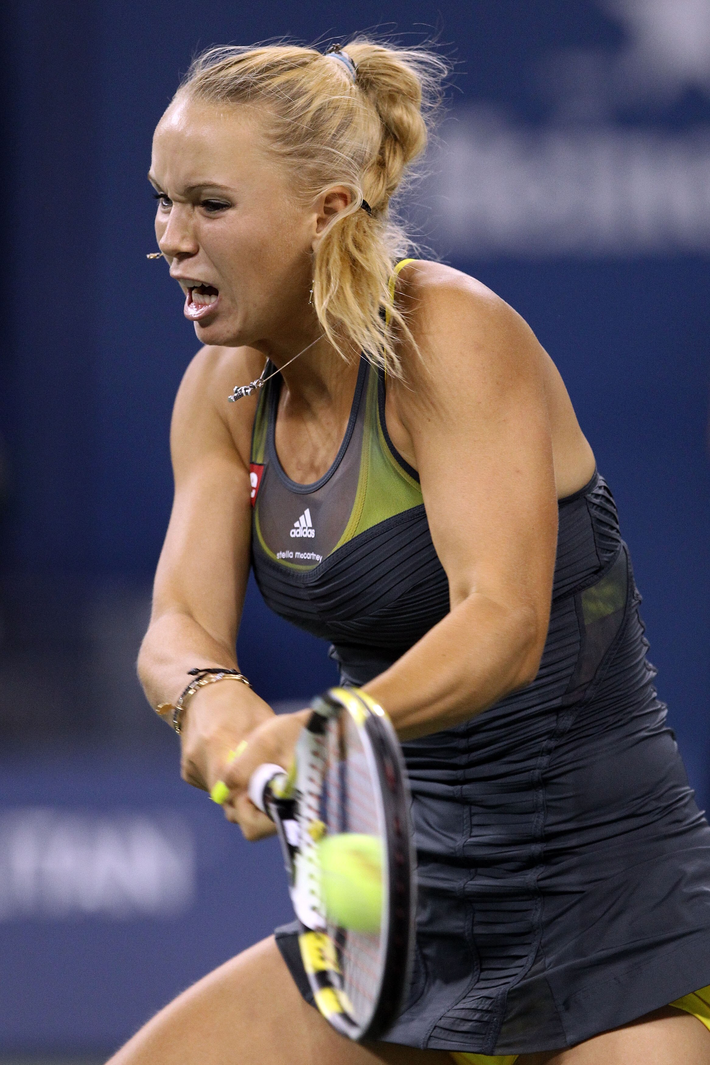 NEW YORK - SEPTEMBER 08:  Caroline Wozniacki of Denmark returns a shot against Dominika Cibulkova of Slovakia during her women's single quarterfinal match during day ten of the 2010 U.S. Open at the USTA Billie Jean King National Tennis Center on Septembe