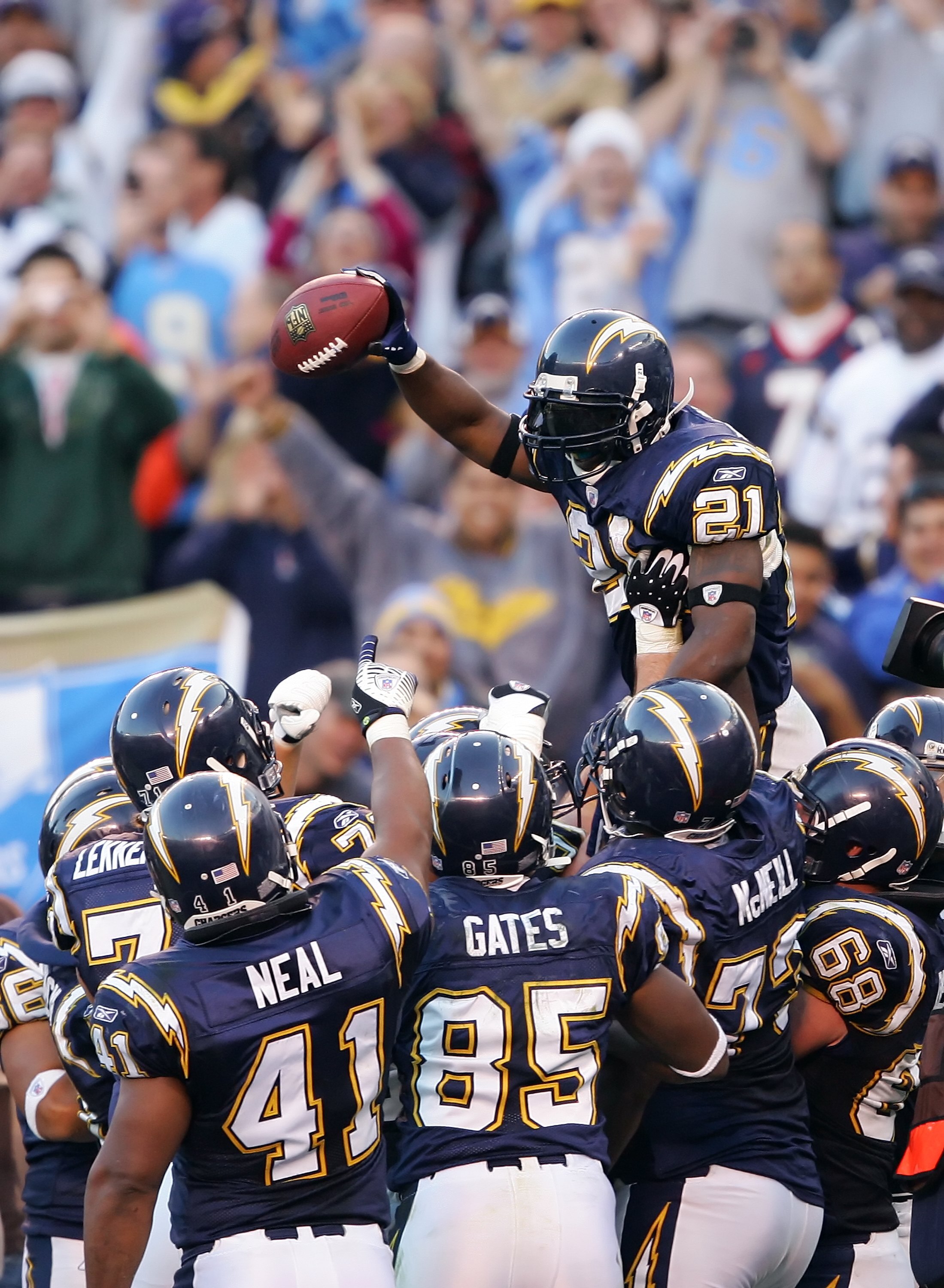 SAN DIEGO, CA - DECEMBER 10:  LaDanian Tomlinson #21 of the San Diego Chargers celebrates with teammates after breaking the NFL record for single season touchdowns with 29 (his third of the day) during the game against the Denver Broncos on December 10, 2