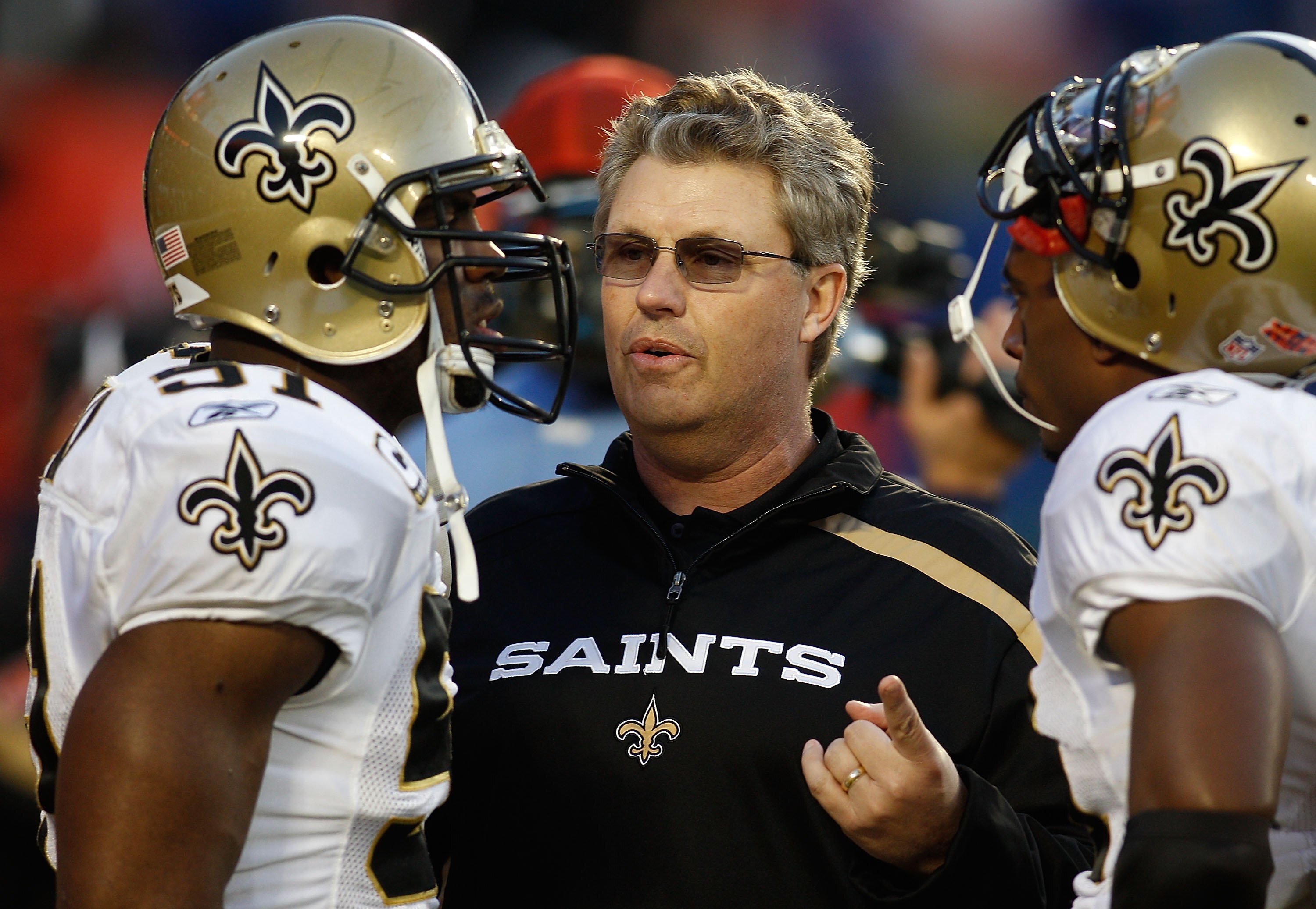 MIAMI GARDENS, FL - FEBRUARY 07:  Defensive coordinator Gregg Williams (C) of the New Orleans Saints talks with Jonathan Vilma #51 (L) and Roman Harper #41 (R) on the field prior to Super Bowl XLIV against the Indianapolis Colts on February 7, 2010 at Sun