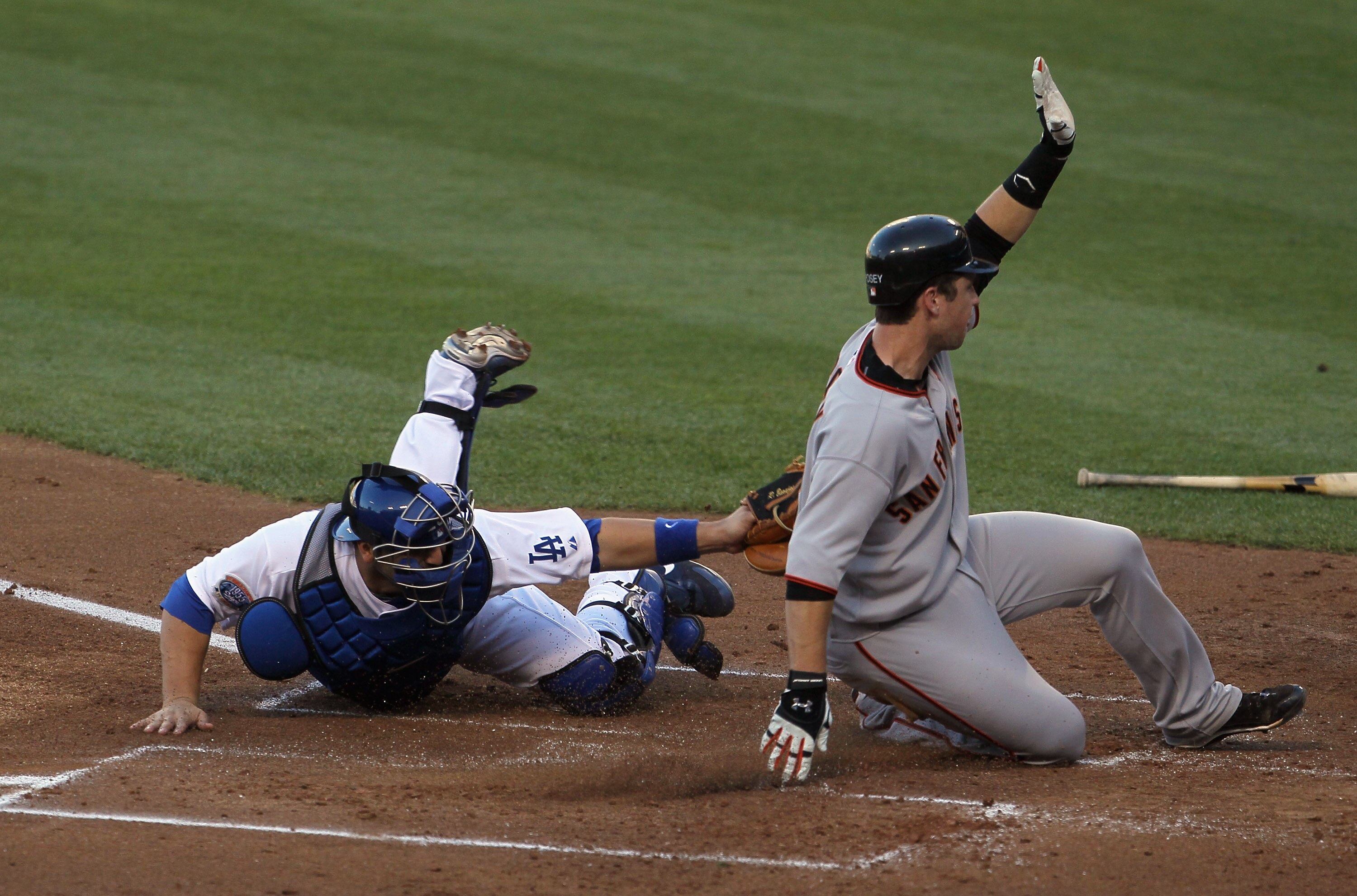 LOS ANGELES, CA - SEPTEMBER 05:  Buster Posey #28 of the San Francisco Giants slides safely past catcher Rod Barajas #28 of the Los Angeles Dodgers in the second inning at Dodger Stadium on September 5, 2010 in Los Angeles, California.  (Photo by Jeff Gro