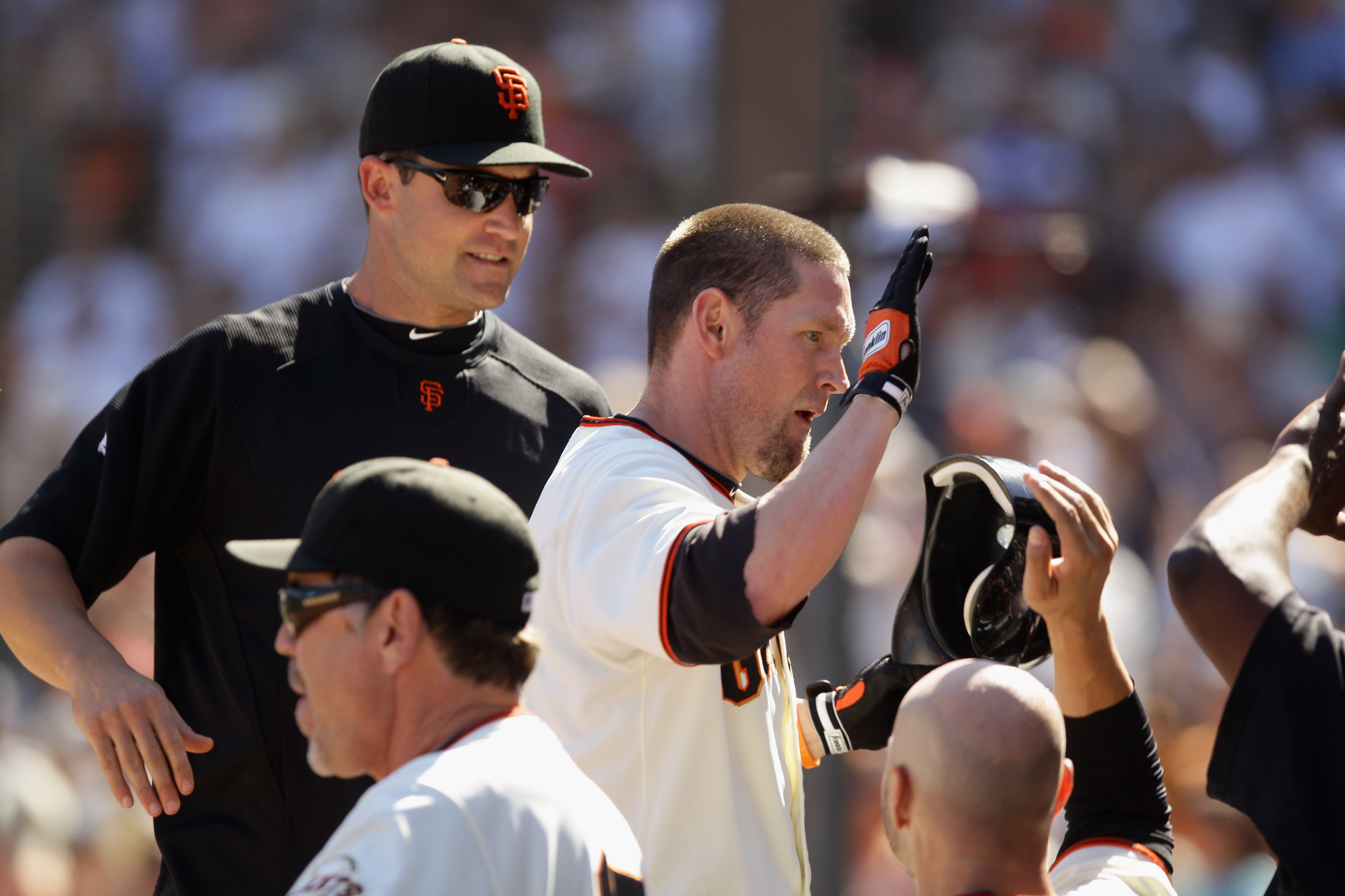 SAN FRANCISCO - AUGUST 25:  Aubrey Huff #17 of the San Francisco Giants is congratulated by teaemmates after he hit a sac fly that scored Andres Torres to put the Giants ahead 11-10 in the eighth inning of their game against the Cincinnati Reds at AT&T Pa