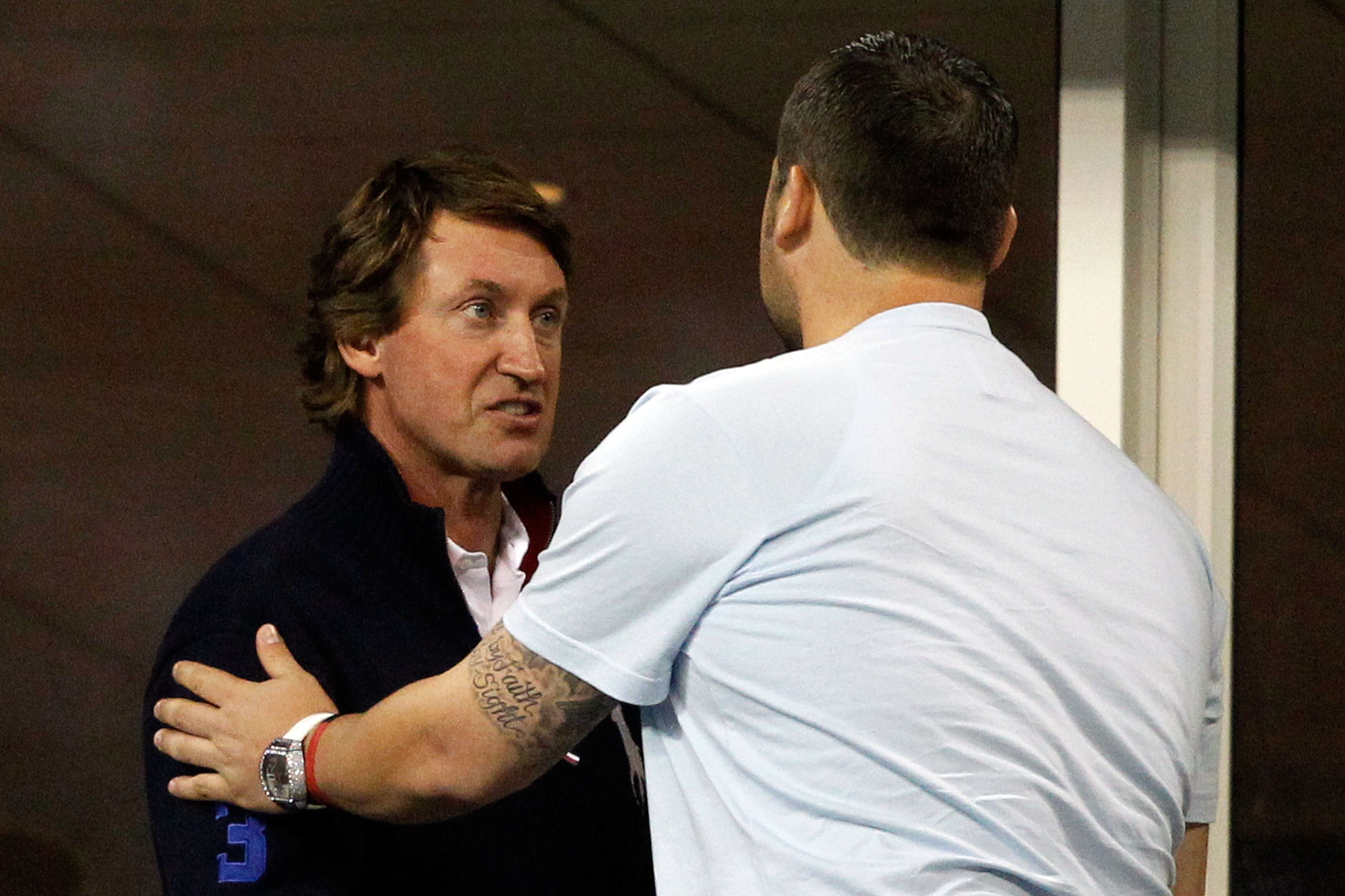NEW YORK - SEPTEMBER 08:  Wayne Gretzky (L) and Joba Chamberlain look on as Robin Soderling of Sweden plays against Roger Federer of Switzerland during their men's singles quarterfinal match on day ten of the 2010 U.S. Open at the USTA Billie Jean King Na