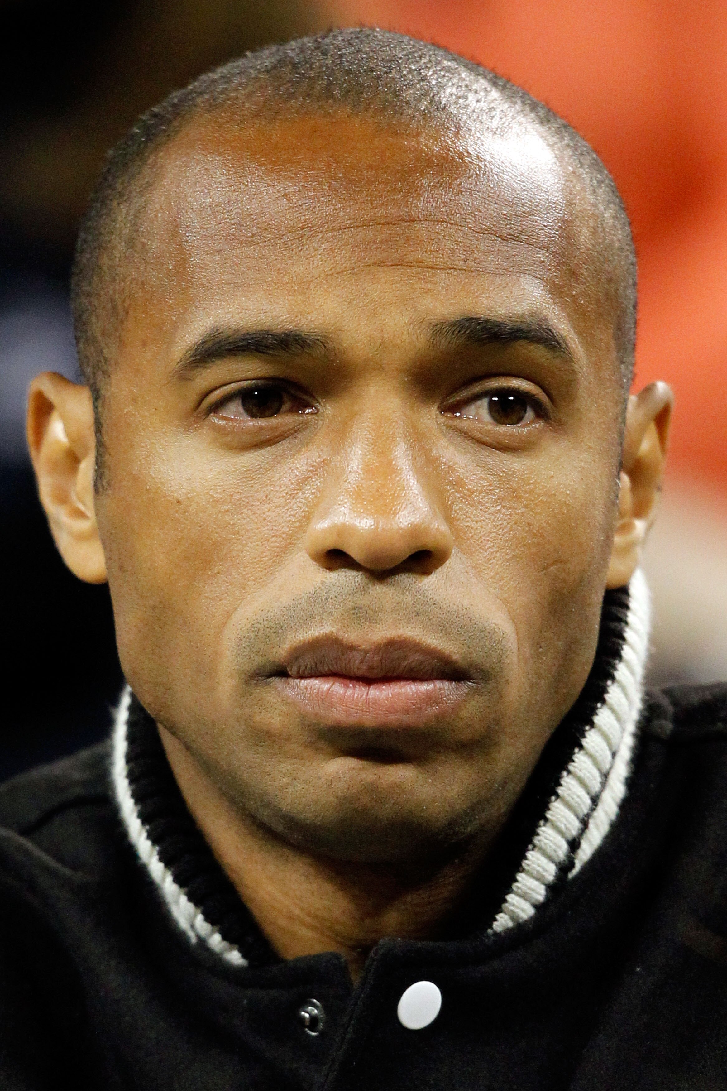 NEW YORK - SEPTEMBER 08:  Thierry Henry looks on as Robin Soderling of Sweden plays against Roger Federer of Switzerland during their men's singles quarterfinal match on day ten of the 2010 U.S. Open at the USTA Billie Jean King National Tennis Center on 
