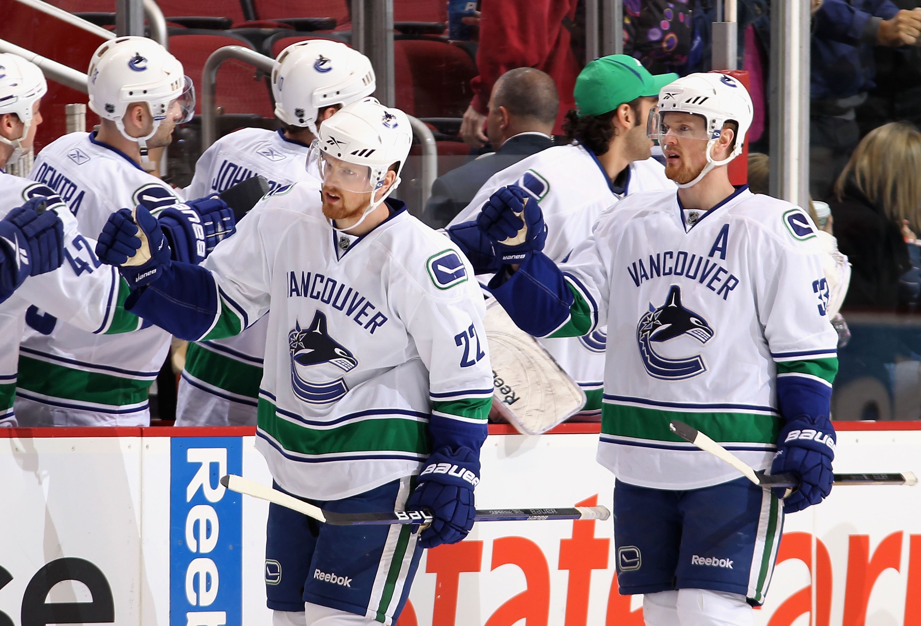 GLENDALE, AZ - MARCH 10:  Daniel Sedin #22 and Henrik Sedin #33 of the Vancouver Canucks celebrate with teammates after scoring during the NHL game against the Phoenix Coyotes at Jobing.com Arena on March 10, 2010 in Glendale, Arizona.  The Coyotes defeat