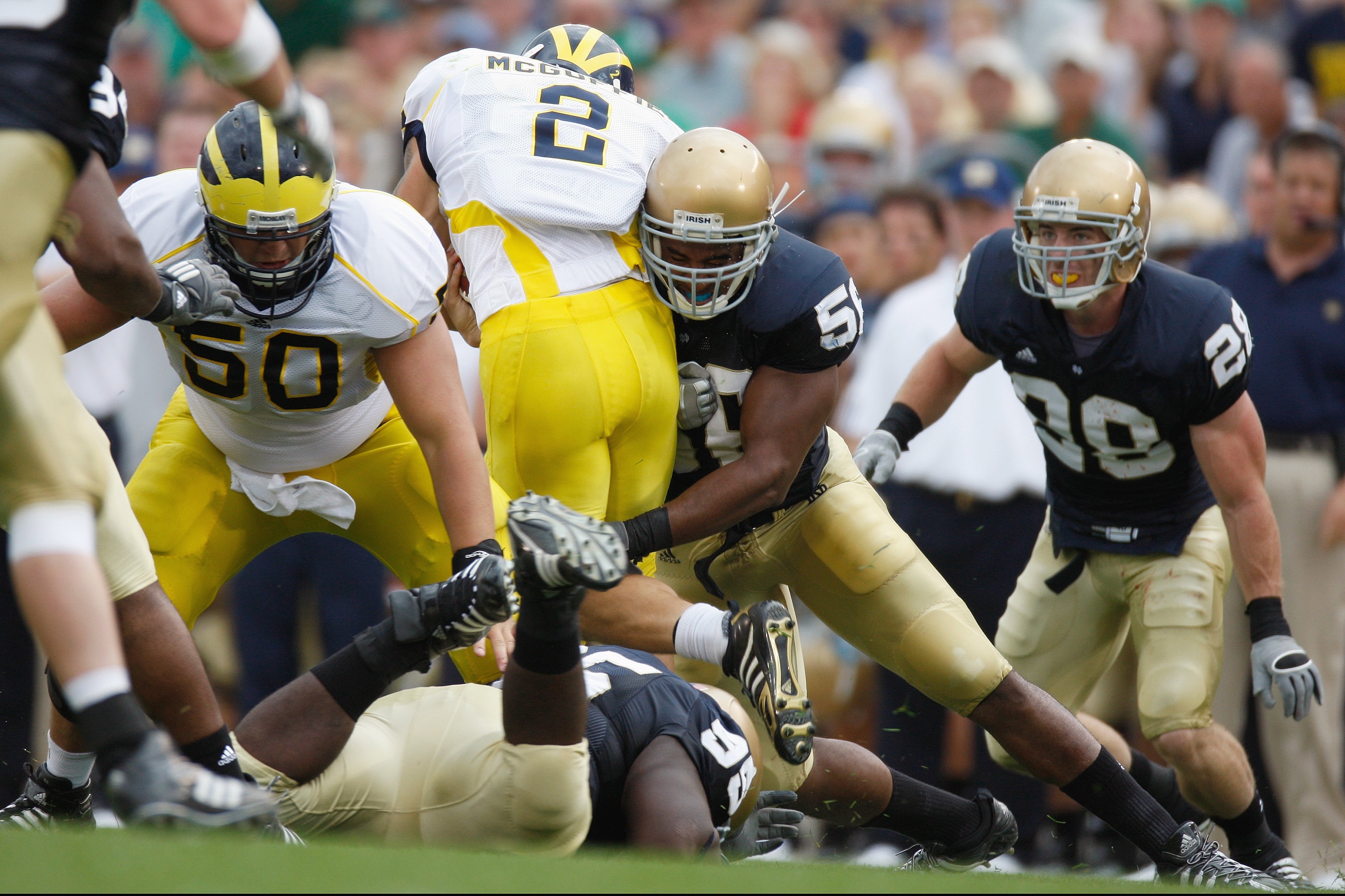 SOUTH BEND,IN - SEPTEMBER 13:  Neal Kerry #56 of the Notre Dame Fighting Irish tackles Sam McGuffie #2 during the game against the Michigan Wolverines on September 13, 2008 at Notre Dame Stadium in South Bend, Indiana. (Photo by: Gregory Shamus/Getty Imag