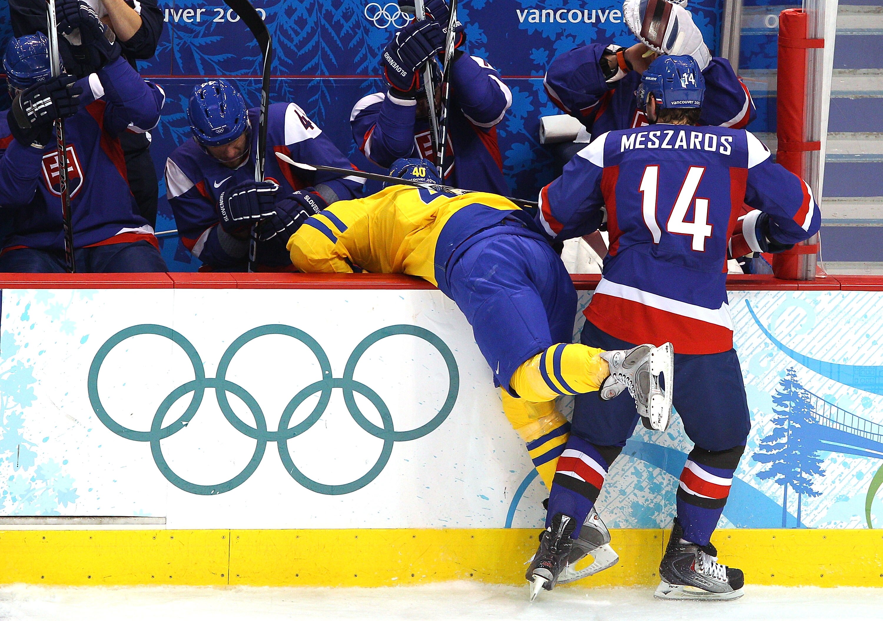 VANCOUVER, BC - FEBRUARY 24: Andrej Meszaros #14 of Slovakia checks Henrik Zetterberg #40 of Sweden into the Slovakia bench in the first period during the ice hockey men's quarter final game between Sweden and Slovakia on day 13 of the Vancouver 2010 Win VANCOUVER, BC - FEBRUARY 24: Andrej Meszaros #14 of Slovakia checks Henrik Zetterberg #40 of Sweden into the Slovakia bench in the first period during the ice hockey men's quarter final game between Sweden and Slovakia on day 13 of the Vancouver 2010 Win