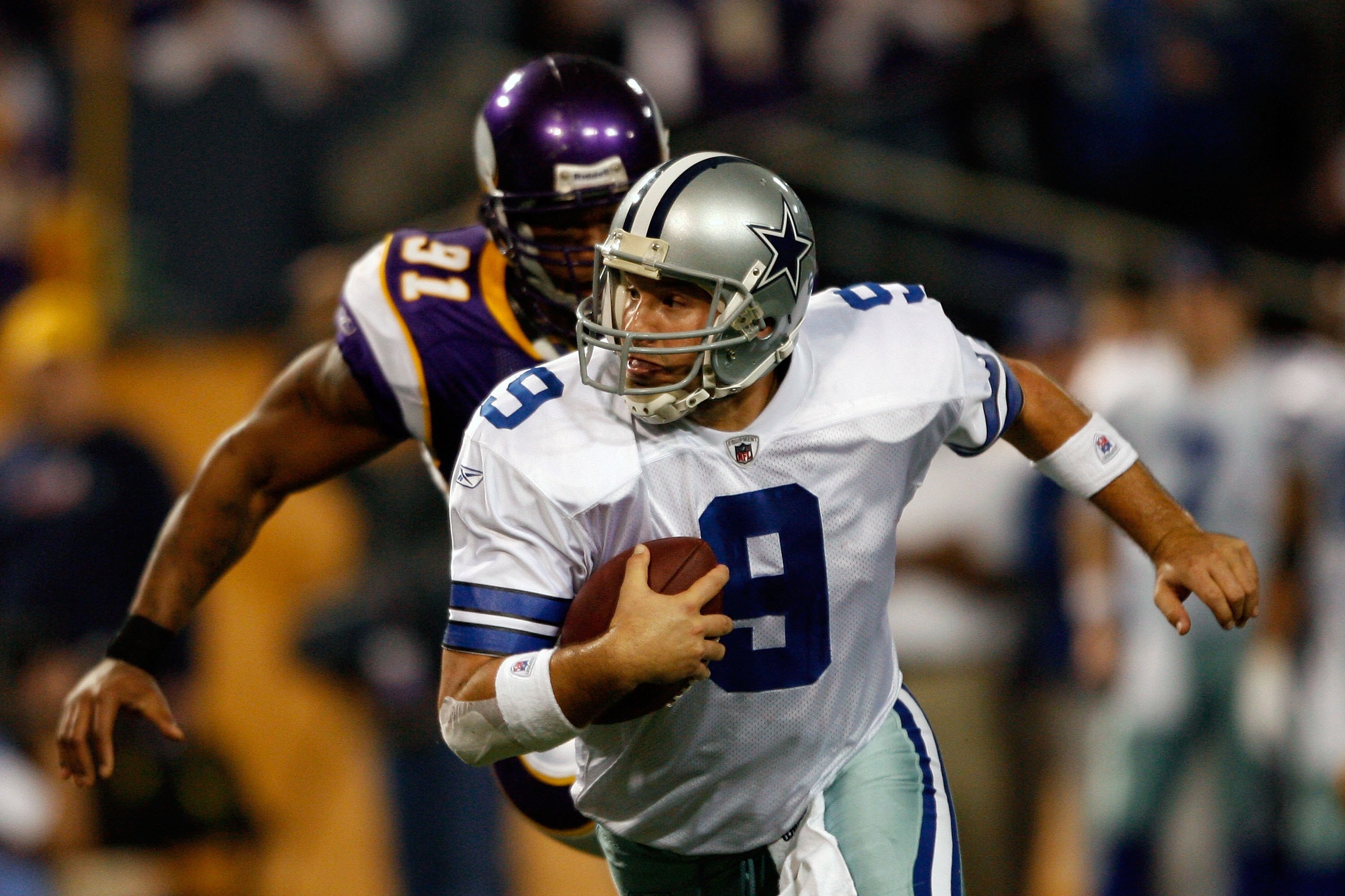 MINNEAPOLIS - JANUARY 17:  Tony Romo #9 of the Dallas Cowboys runs the ball against Ray Edwards #91 of the Minnesota Vikings during the NFC Divisional Playoff Game at Hubert H. Humphrey Metrodome on January 17, 2010 in Minneapolis, Minnesota. The Vikings
