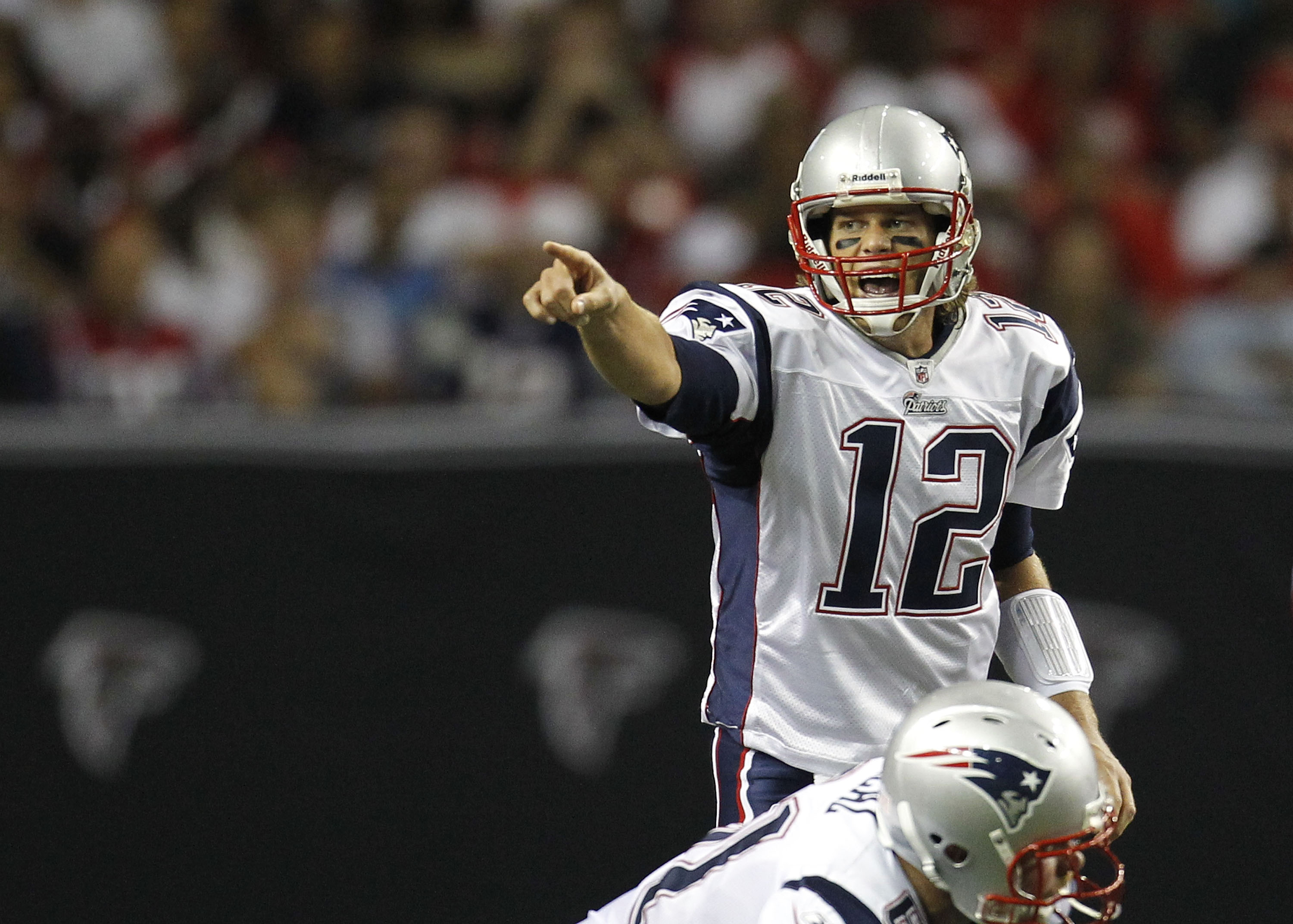 ATLANTA - AUGUST 19:  Quarterback Tom Brady #12 of the New England Patriots points out the defensive alignment during the preseason game against the Atlanta Falcons at the Georgia Dome on August 19, 2010 in Atlanta, Georgia.  (Photo by Mike Zarrilli/Getty