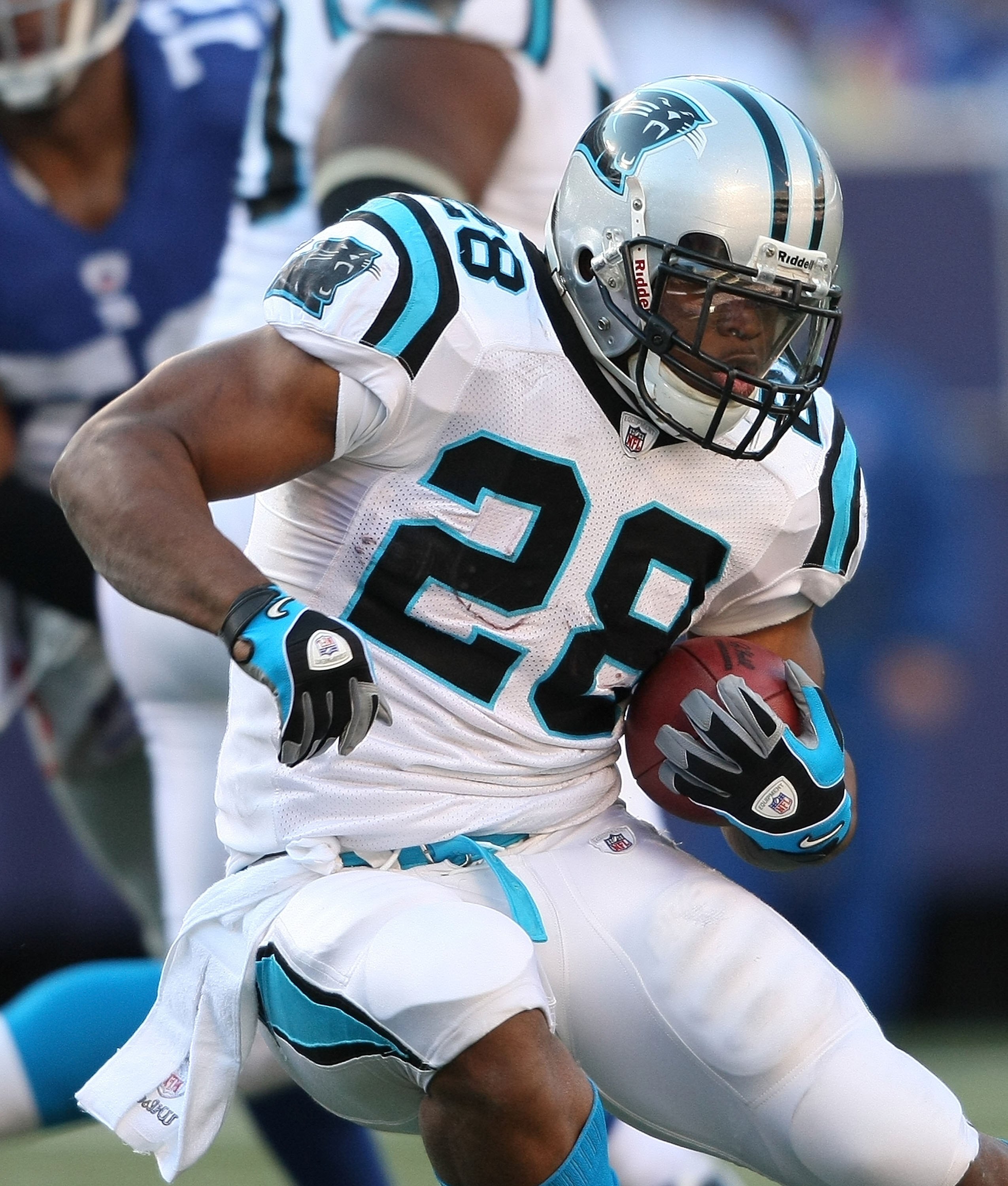EAST RUTHERFORD, NJ - DECEMBER 27:  Jonathan Stewart #28 of the Carolina Panthers rushes against the New York Giants at Giants Stadium on December 27, 2009 in East Rutherford, New Jersey.  (Photo by Nick Laham/Getty Images)