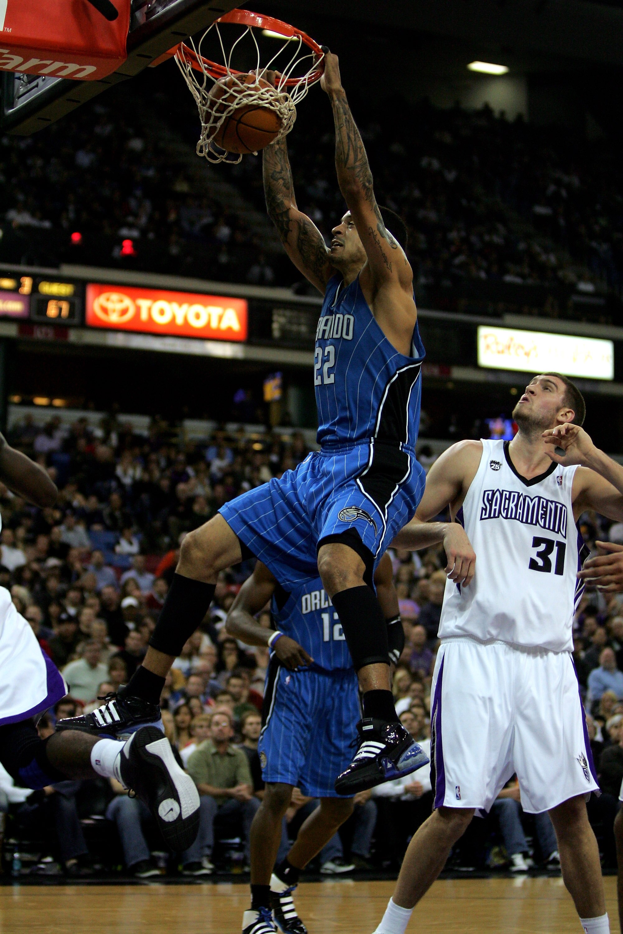 SACRAMENTO, CA - JANUARY 12: Matt Barnes #22 of the Orlando Magic dunks the ball while Spencer Hawes #31 of the Sacramento Kings looks on at ARCO Arena on January 12, 2010 in Sacramento, California. NOTE TO USER: User expressly acknowledges and agrees t SACRAMENTO, CA - JANUARY 12: Matt Barnes #22 of the Orlando Magic dunks the ball while Spencer Hawes #31 of the Sacramento Kings looks on at ARCO Arena on January 12, 2010 in Sacramento, California. NOTE TO USER: User expressly acknowledges and agrees t