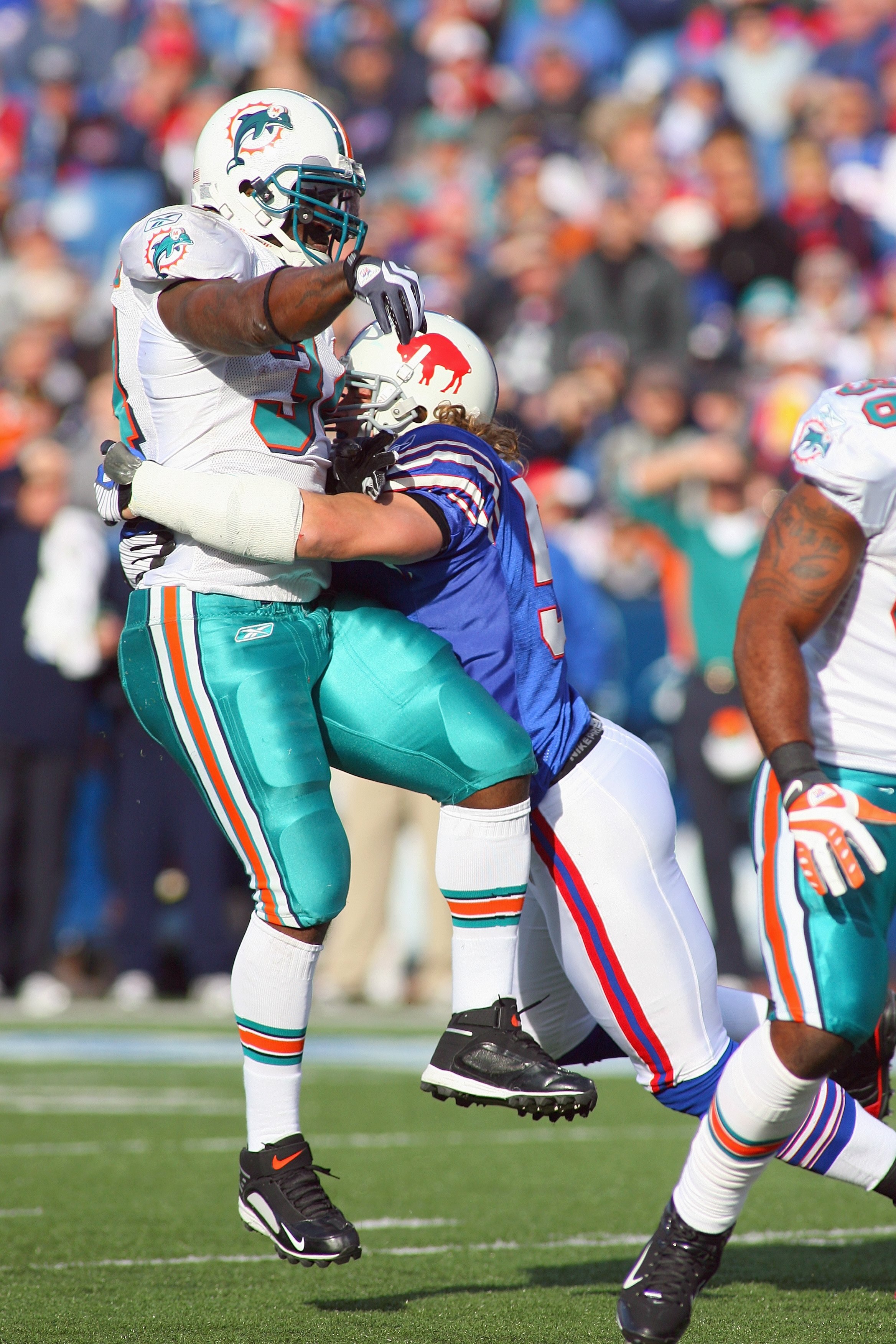 ORCHARD PARK, NY - NOVEMBER 29: Ricky Williams #34 of the Miami Dolphins is hit by Paul Posluszny #51 of the Buffalo Bills as he throws a pass that is intercepted in the endzone at Ralph Wilson Stadium on November 29, 2009 in Orchard Park, New York. Buffa ORCHARD PARK, NY - NOVEMBER 29: Ricky Williams #34 of the Miami Dolphins is hit by Paul Posluszny #51 of the Buffalo Bills as he throws a pass that is intercepted in the endzone at Ralph Wilson Stadium on November 29, 2009 in Orchard Park, New York. Buffa