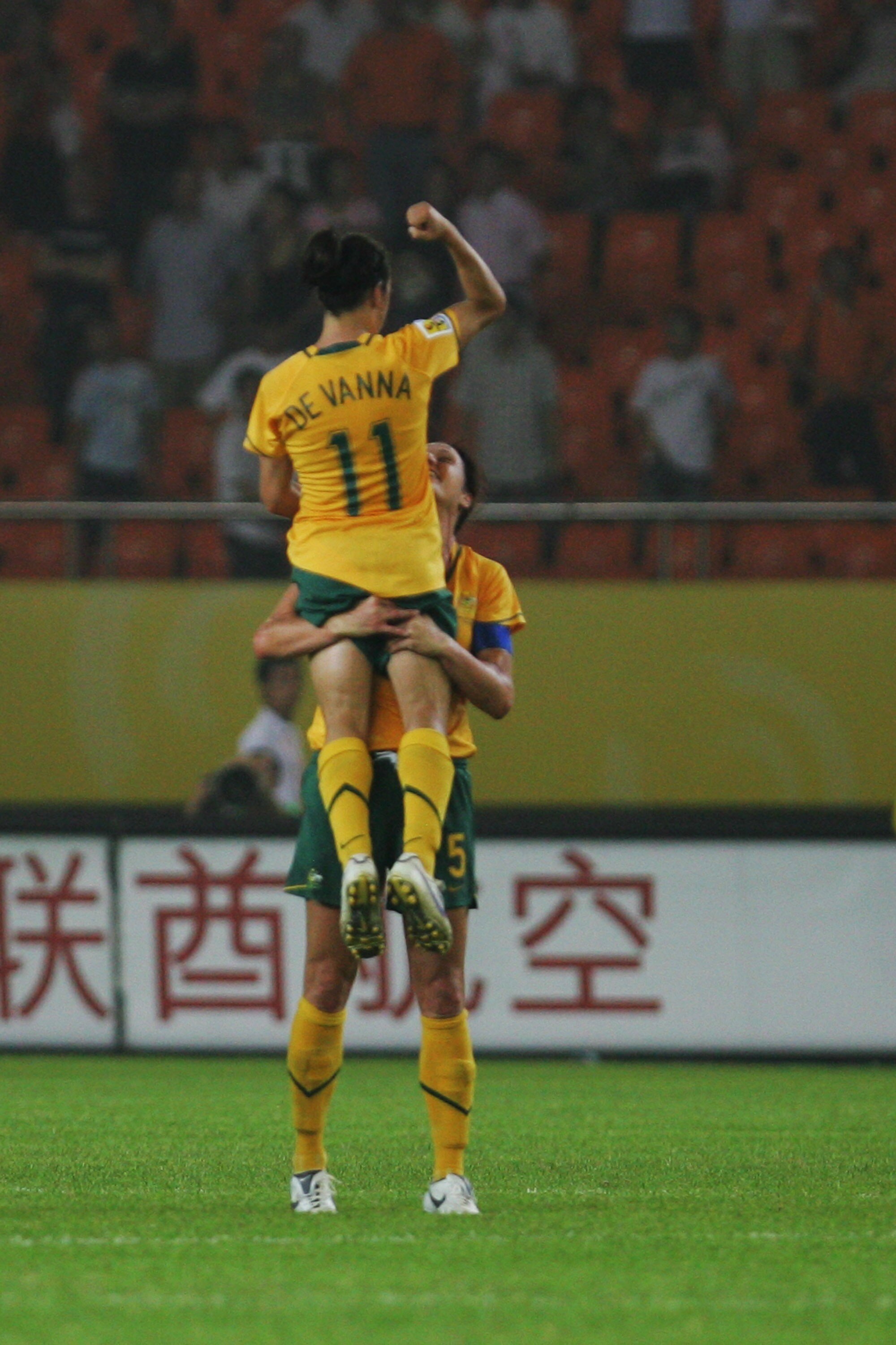 HANGZHOU, ZHEJIANG - SEPTEMBER 15:  Australia's  Cheryl Salisbury (5#) holds Lisa De Vanna (R 11#)  to celebrate the 1-1 draw after the FIFA Women's World Cup 2007 Group C match between Australia and Norway at Hangzhou Dragon Stadium on September 15, 2007