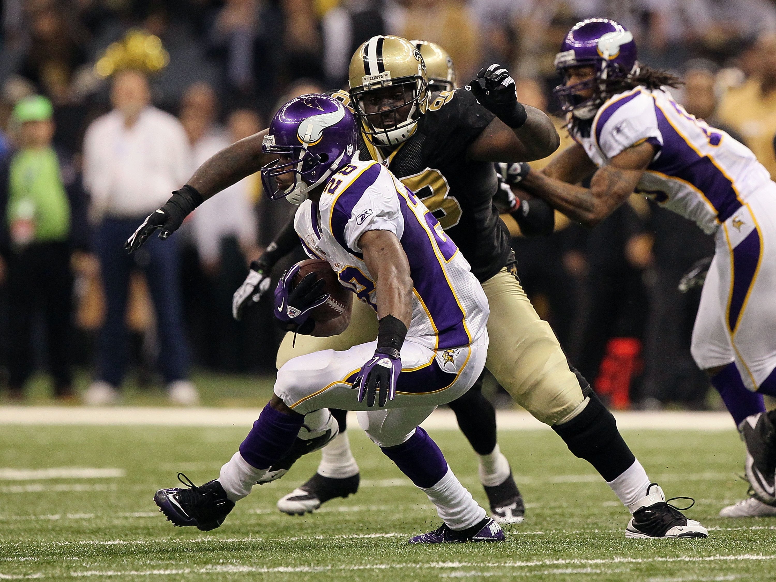 NEW ORLEANS - JANUARY 24:  Adrian Peterson #28 of the Minnesota Vikings runs the ball against Sedrick Ellis #98 of the New Orleans Saints during the NFC Championship Game at the Louisiana Superdome on January 24, 2010 in New Orleans, Louisiana. The Saints