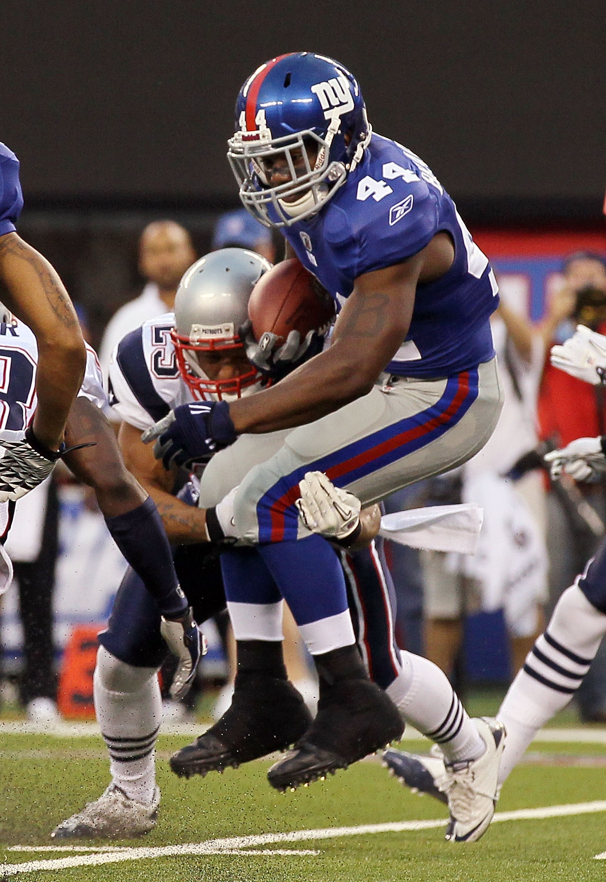 EAST RUTHERFORD, NJ - SEPTEMBER 02:  Ahmad Bradshaw #44 of the New York Giants is tackled by Patrick Chung #25 of the New England Patriots on September 2, 2010 at the New Meadowlands Stadium in East Rutherford, New Jersey.  (Photo by Jim McIsaac/Getty Ima