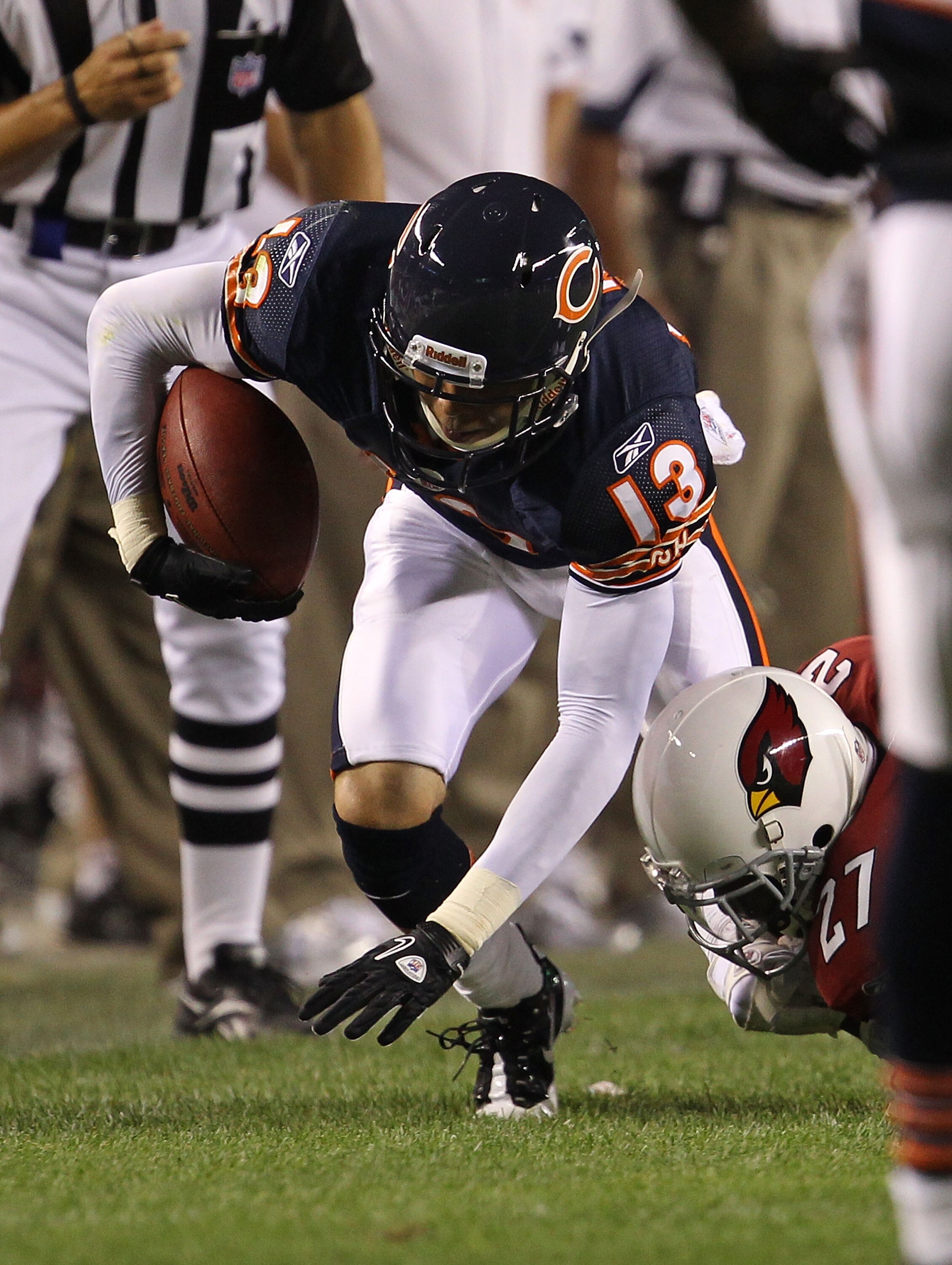 CHICAGO - AUGUST 28: Johnny Knox #13 of the Chicago Bears tries to regain his balance after catching a pass as Michael Adams #27 of the Arizona Cardinals grabs his leg during a preseason game at Soldier Field on August 28, 2010 in Chicago, Illinois. The C