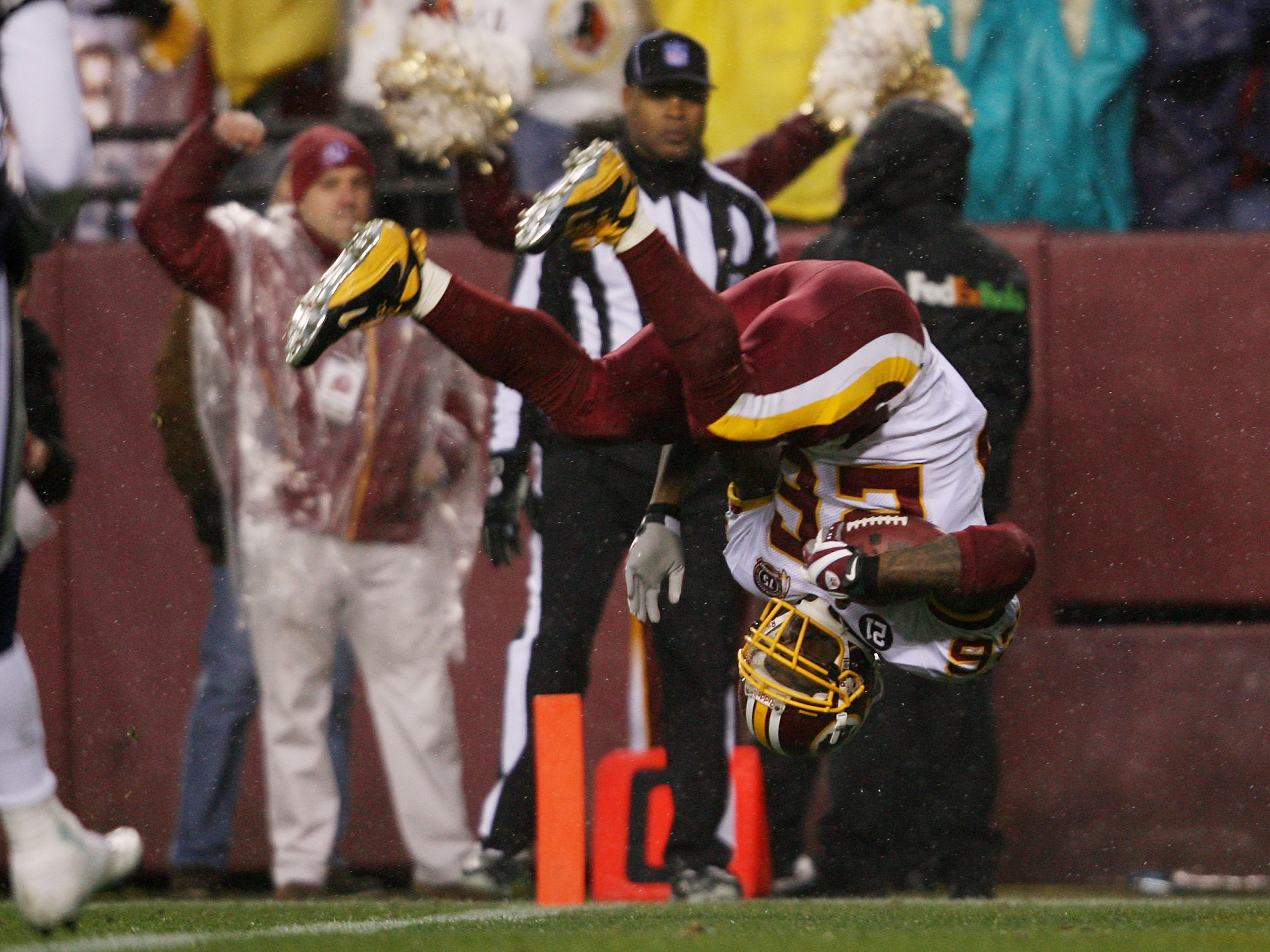 LANDOVER, MD  - DECEMBER 30:   Clinton Portis #26 of the Washington Redskins does a somersault into the endzone as he scores a first quarter touchdown against the Dallas Cowboys on his way to a touchdown on December 30, 2007 at FedEx Field in Landover, Ma