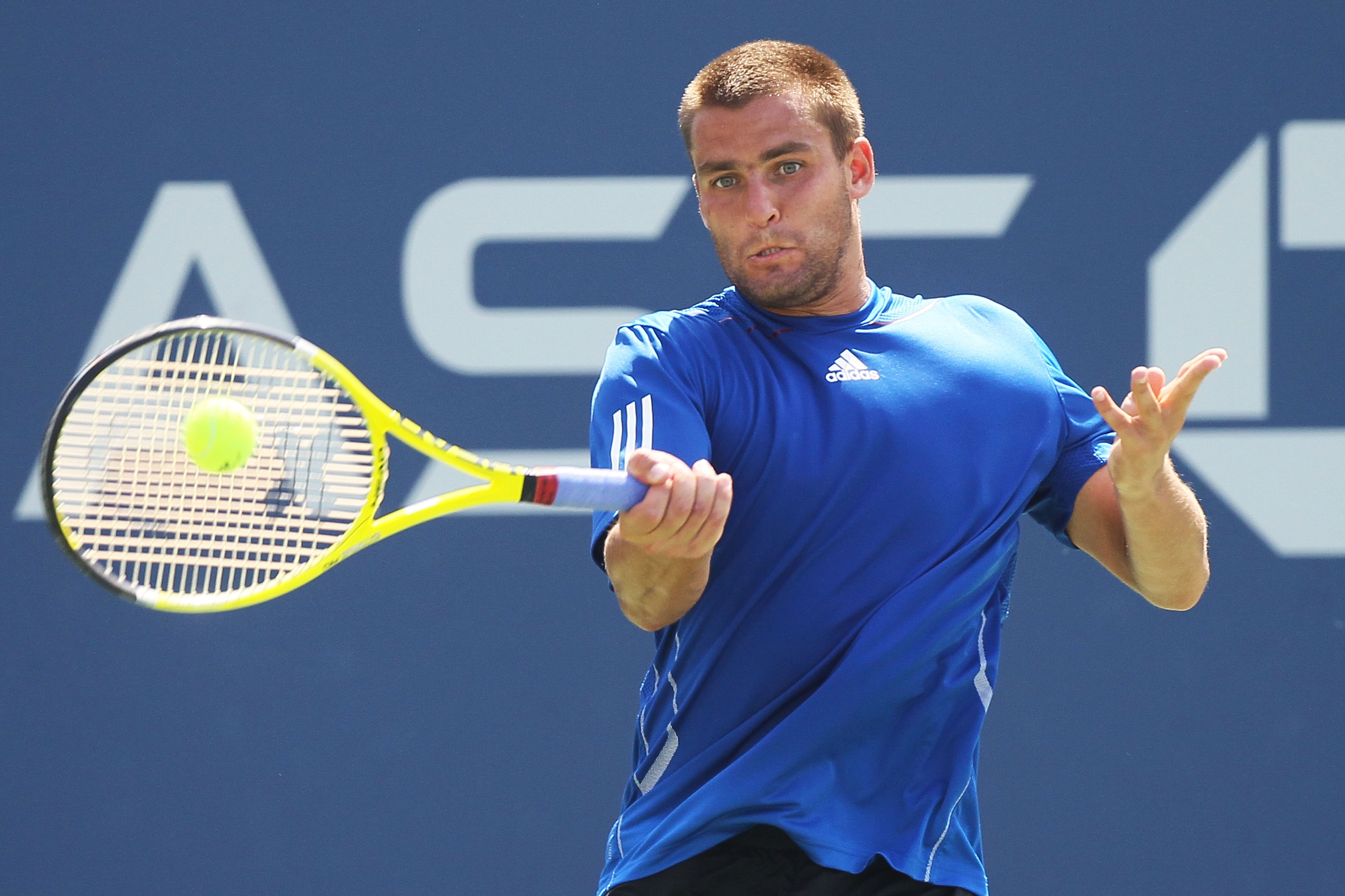 NEW YORK - SEPTEMBER 07:  Mikhail Youzhny of Russia returns a shot against Tommy Robredo of Spain during his men's singles fourth round match on day nine of the 2010 U.S. Open at the USTA Billie Jean King National Tennis Center on September 7, 2010 in the