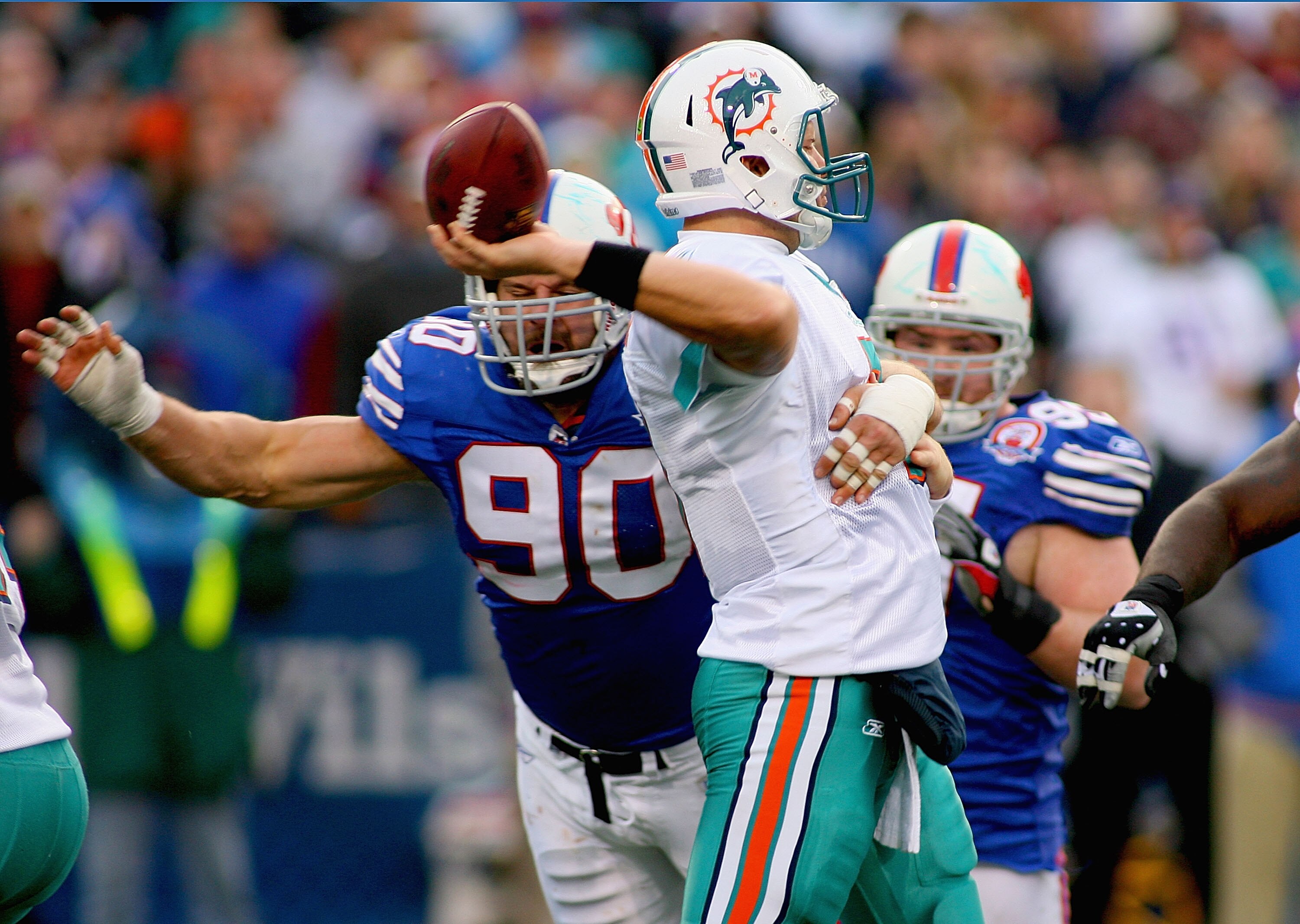 ORCHARD PARK, NY - NOVEMBER 29: Chad Henne #7 of the Miami Dolphins throws a pass as he is pressured by Chris Kelsey #90 of the Buffalo Bills at Ralph Wilson Stadium on November 29, 2009 in Orchard Park, New York. Buffalo won 31-14. (Photo by Rick Stew ORCHARD PARK, NY - NOVEMBER 29: Chad Henne #7 of the Miami Dolphins throws a pass as he is pressured by Chris Kelsey #90 of the Buffalo Bills at Ralph Wilson Stadium on November 29, 2009 in Orchard Park, New York. Buffalo won 31-14. (Photo by Rick Stew