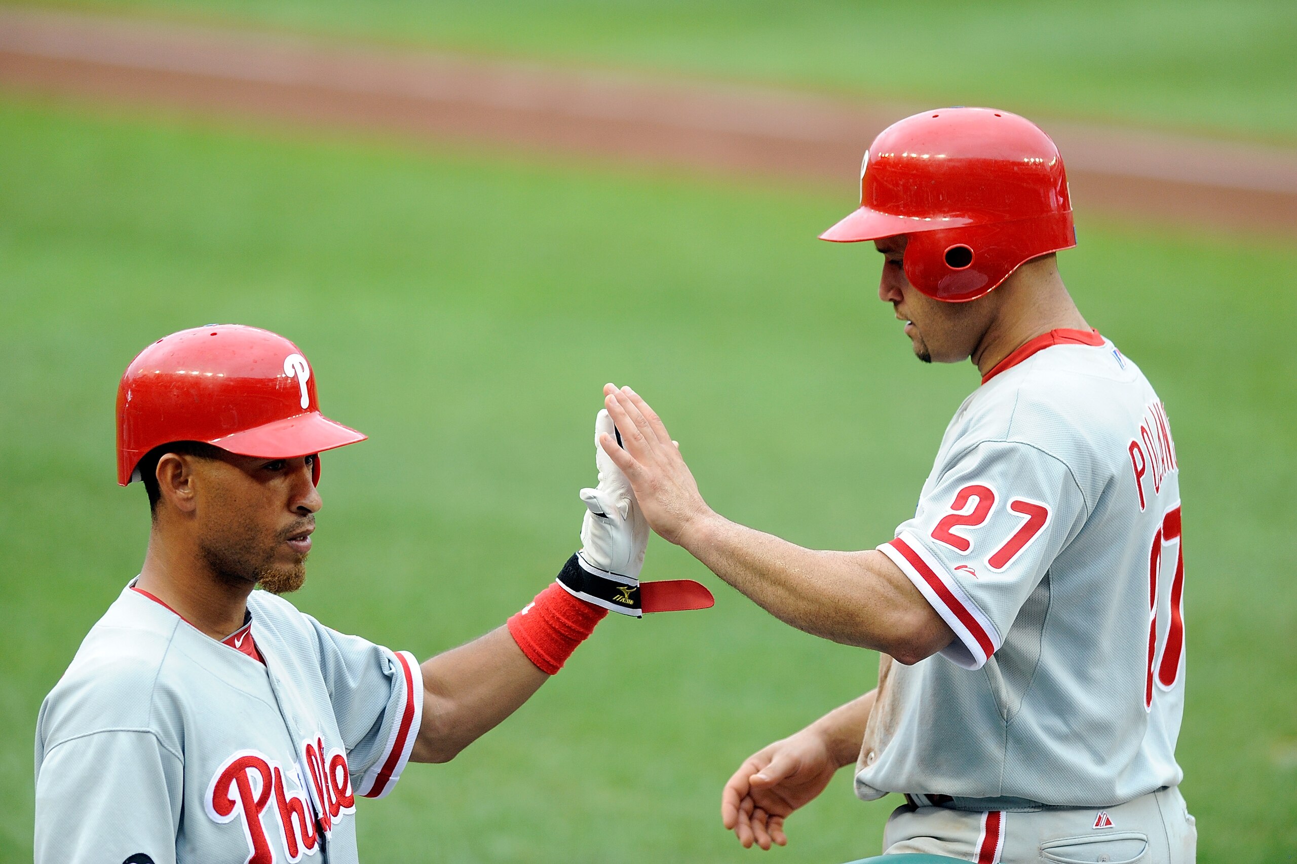 WASHINGTON - AUGUST 01:  Placido Polanco #27 of the Philadelphia Phillies is congratulated by Wilson Valdez #21 after scoring in the seventh inning against the Washington Nationals at Nationals Park on August 1, 2010 in Washington, DC.  (Photo by Greg Fiu
