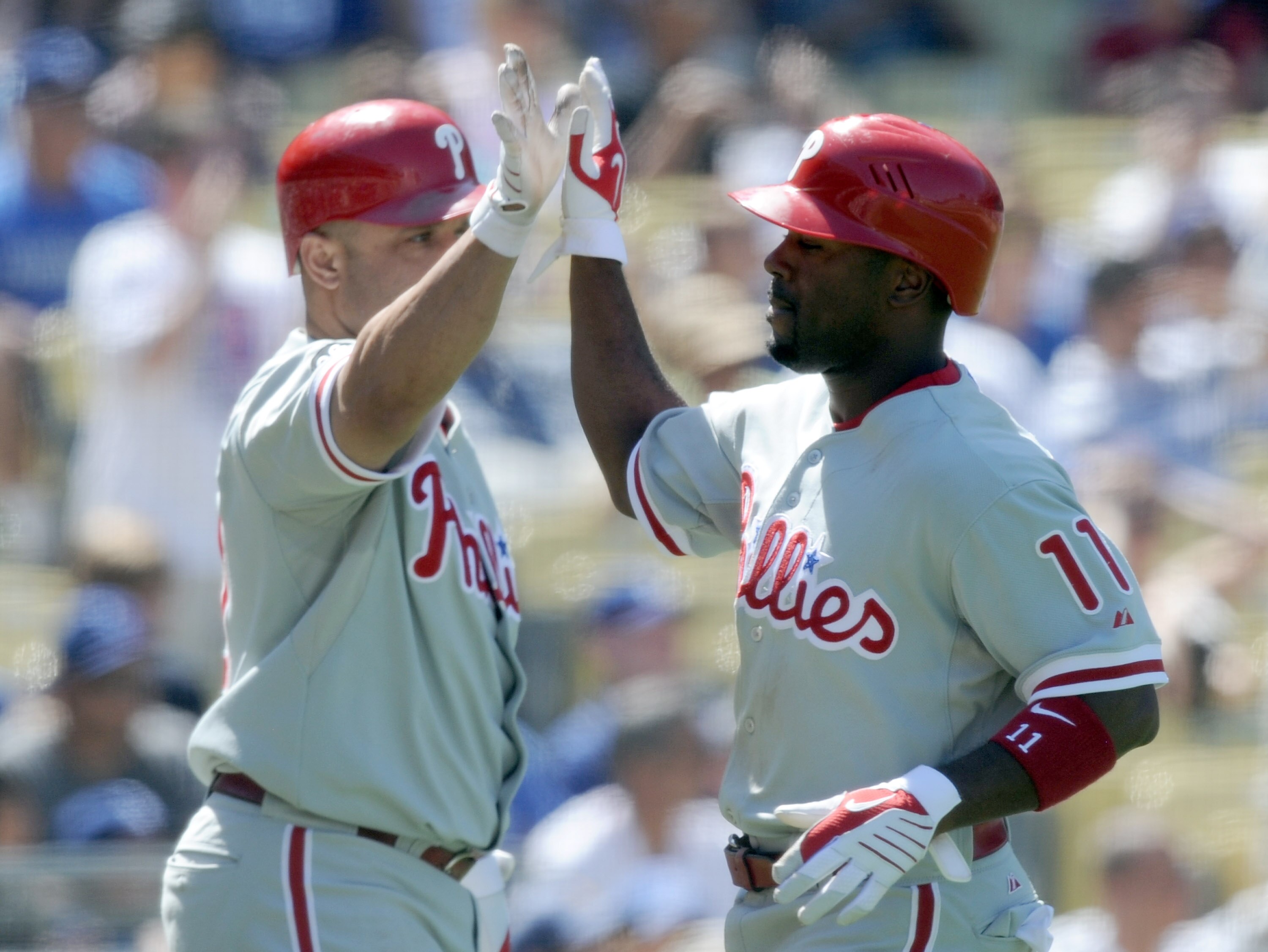 LOS ANGELES, CA - SEPTEMBER 01:  Jimmy Rollins #11 of the Philadelphia Phillies celebrates his run with Placido Polanco #27 off of a Chase Utley #26 double for a 3-0 lead over the Los Angeles Dodgers during the seventh inning at Dodger Stadium on Septembe