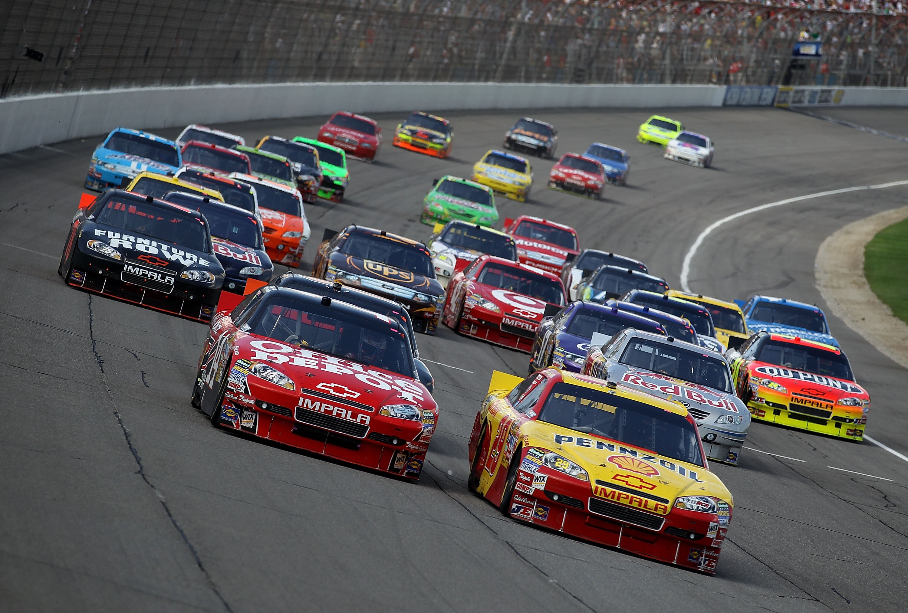 BROOKLYN, MI - AUGUST 15: Kevin Harvick, driver of the #29 Shell/Pennzoil Chevrolet, passes Tony Stewart, driver of the #14 Office Depot/Old Spice Chevrolet on a restart during the NASCAR Sprint Cup Series CARFAX 400 at Michigan International Speedway on 