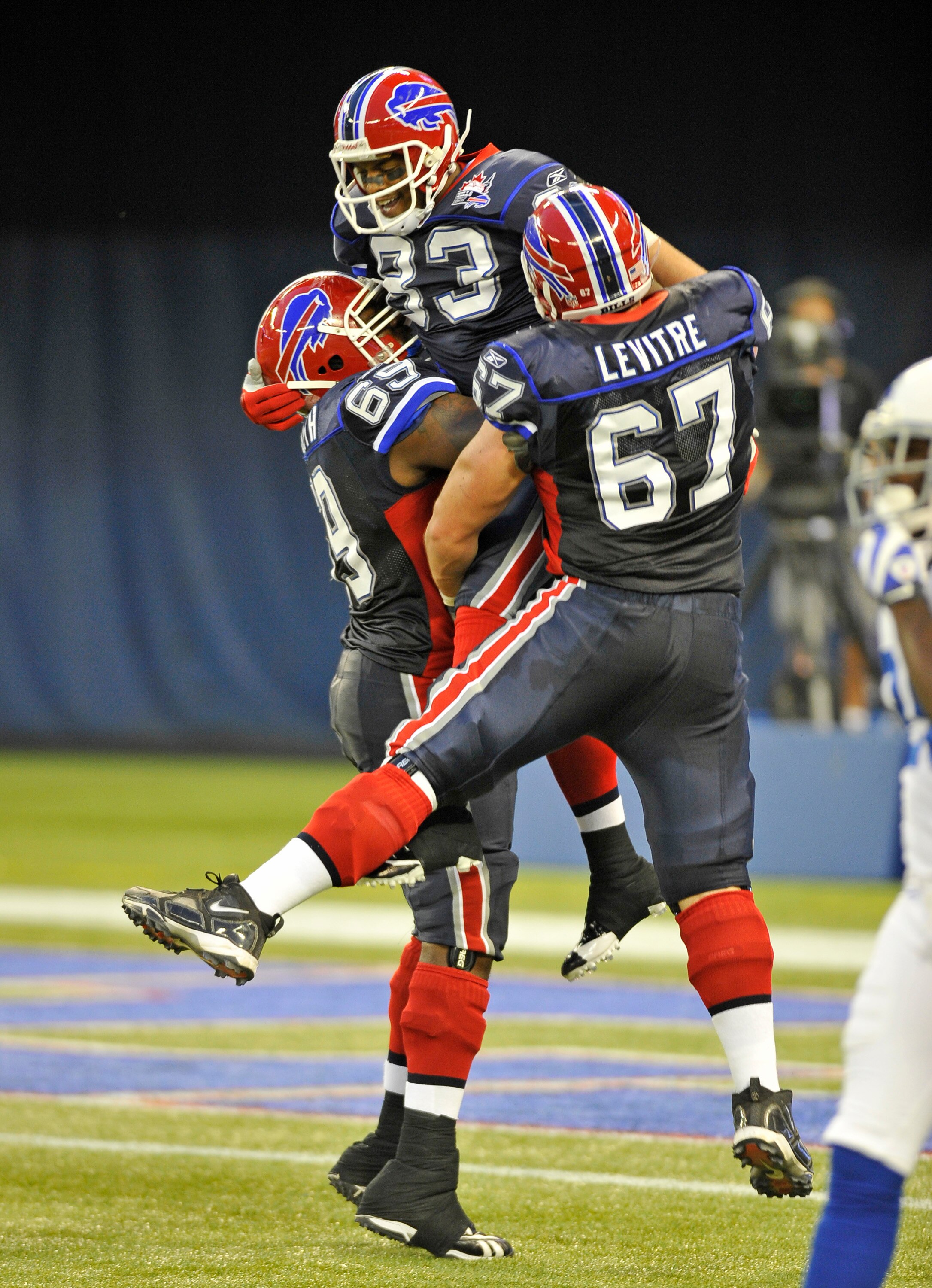 TORONTO - AUGUST 19:  Jamon Meredith # 69, Lee Evens #83 and Andy Levitre #67 of the Buffalo Bills celebrate a first half touchdown against the Indianapolis Colts during game action August 19, 2010 at the Rogers Centre in Toronto, Ontario, Canada. (Photo 