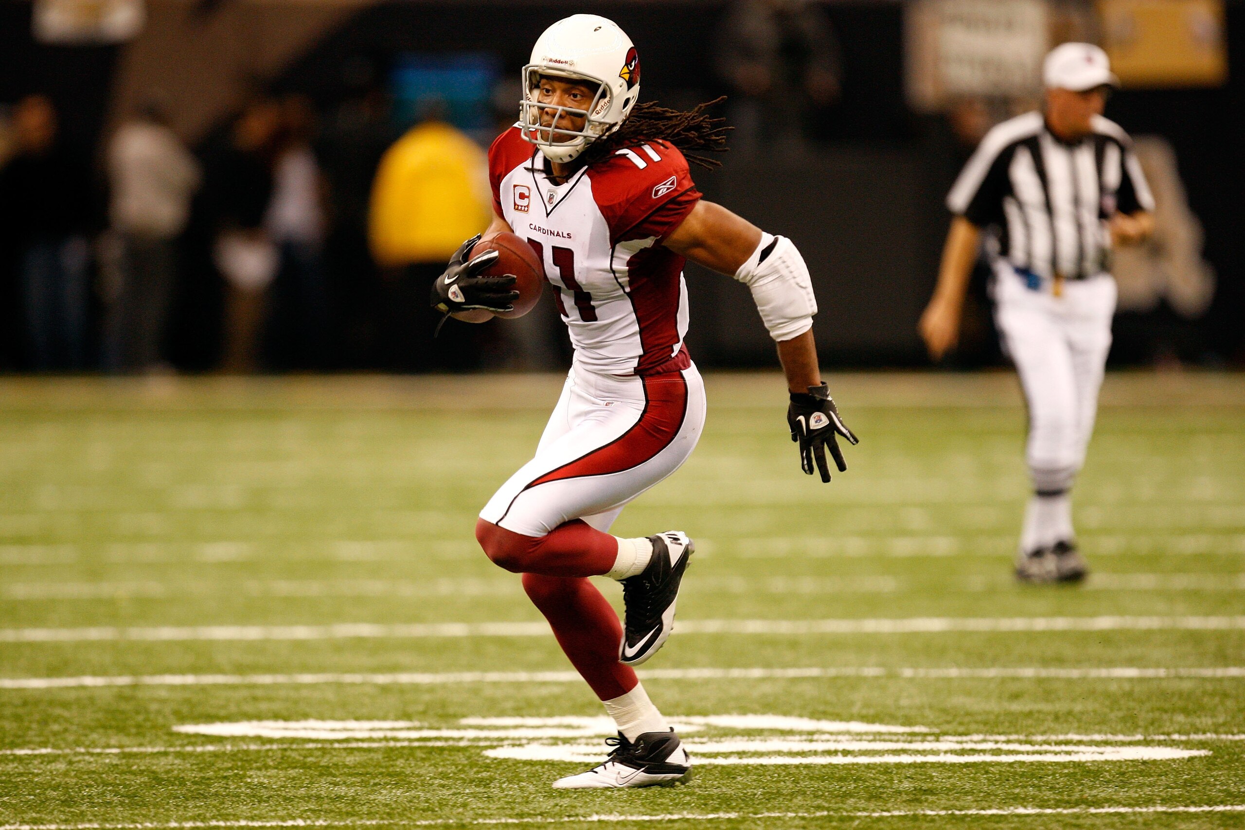 NEW ORLEANS - JANUARY 16:  Larry Fitzgerald #11 of the Arizona Cardinals runs for yards after the catch against the New Orleans Saints during the NFC Divisional Playoff Game at Louisana Superdome on January 16, 2010 in New Orleans, Louisiana. The Saints w
