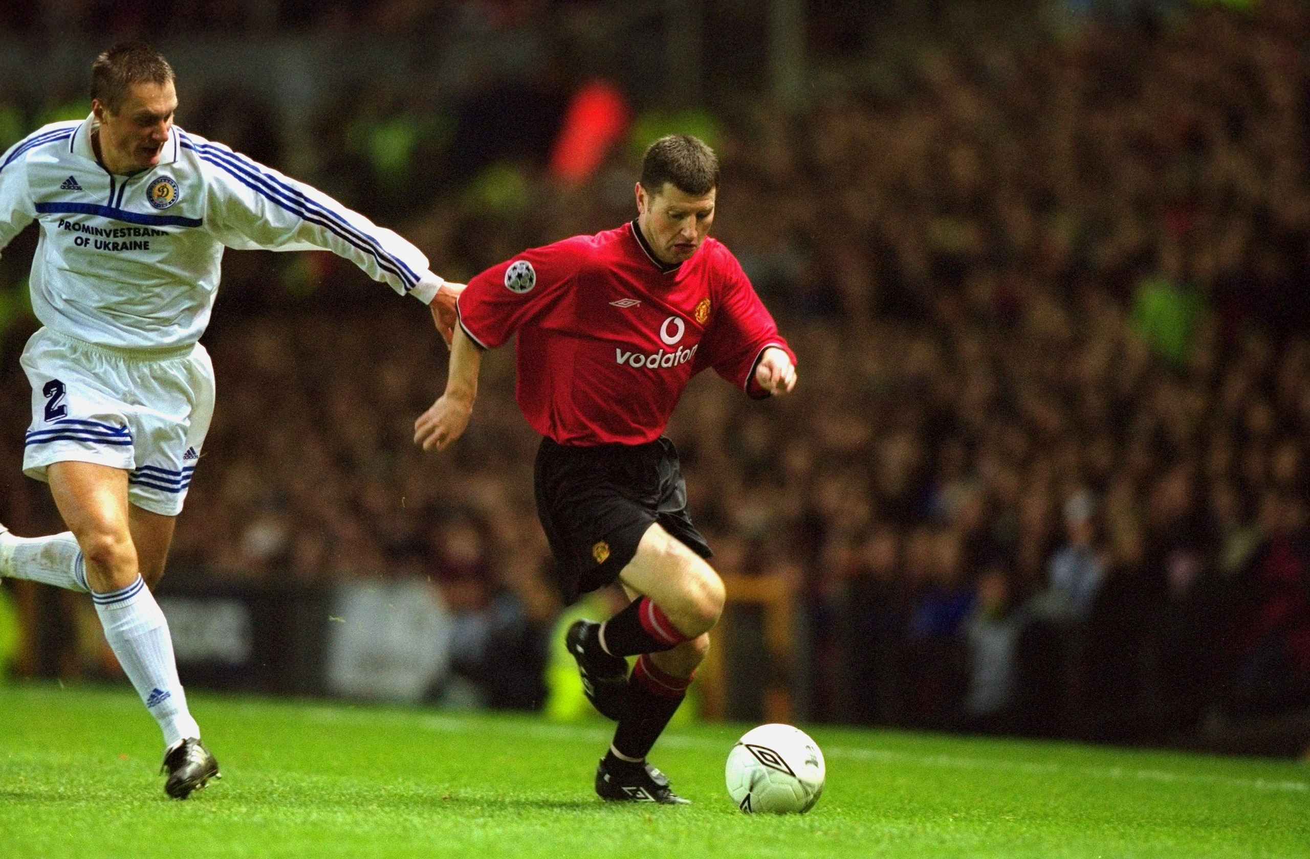 7 Nov 2000:  Denis Irwin of Manchester United takes the ball past Aliaxandr Khatskevitch of Dynamo Kiev during the UEFA Champions League match played at Old Trafford, in Manchester, England. Manchester United won the match 1-0. \ Mandatory Credit: Ben Rad