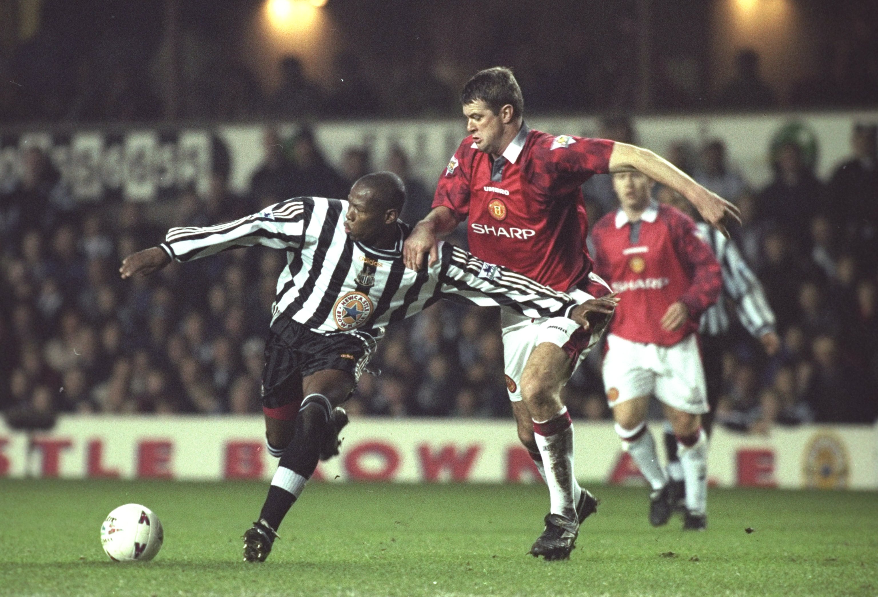 21 Dec 1997:  Faustino Asprilla of Newcastle United (left) holds off the challenge of Gary Pallister of Manchester United during the FA Carling Premiership match at St James'' Park in Newcastle, England. Manchester United won the match 0-1. \ Mandatory Cr
