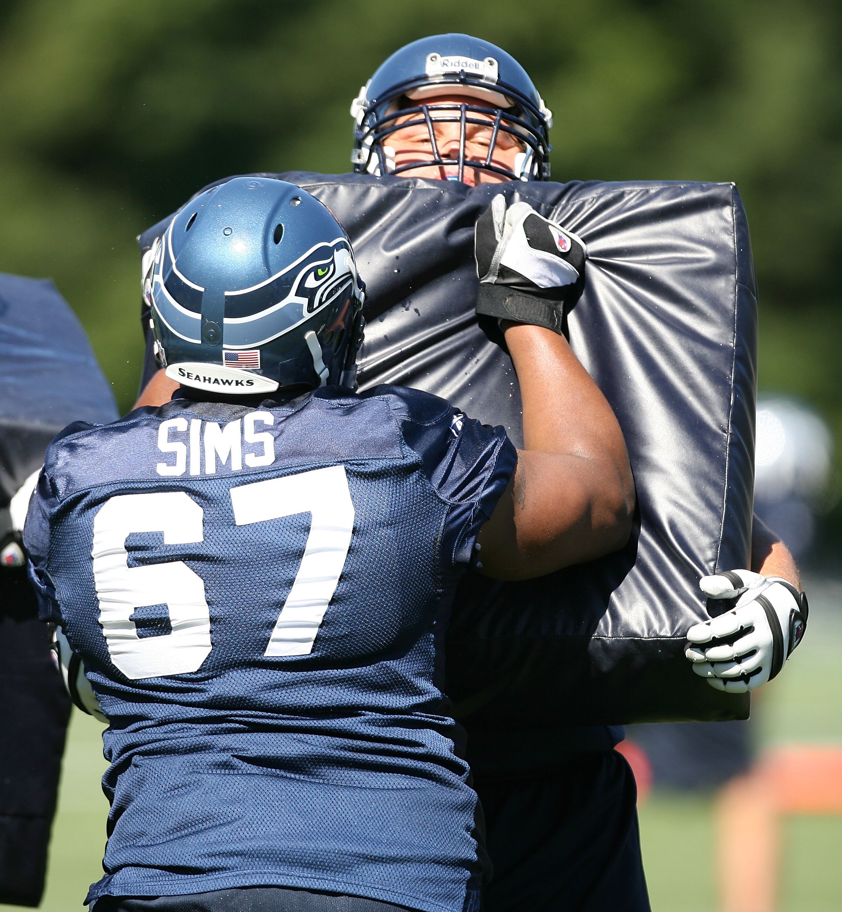 KIRKLAND, WA - JULY 31:  Guard Steve Vallos #69 of the Seattle Seahawks holds a pad in a blocking drill against Rob Sims #67 in training camp on July 31, 2007 at Seahawks Headquarters in Kirkland, Washington.  (Photo by Otto Greule Jr/Getty Images)