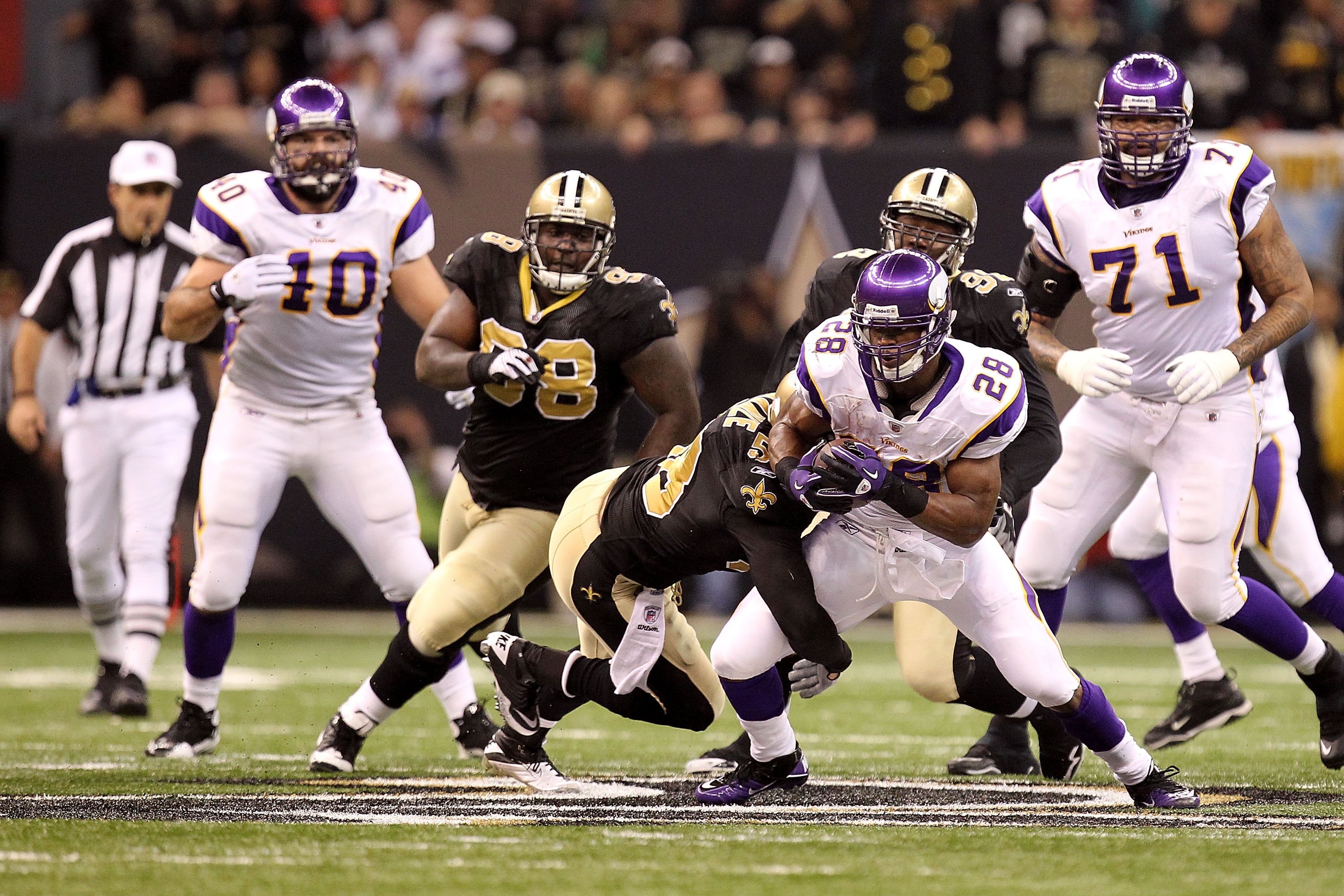 NEW ORLEANS - JANUARY 24:  Adrian Peterson #28 of the Minnesota Vikings runs the ball against the New Orleans Saints during the NFC Championship Game at the Louisana Superdome on January 24, 2010 in New Orleans, Louisiana.  (Photo by Ronald Martinez/Getty