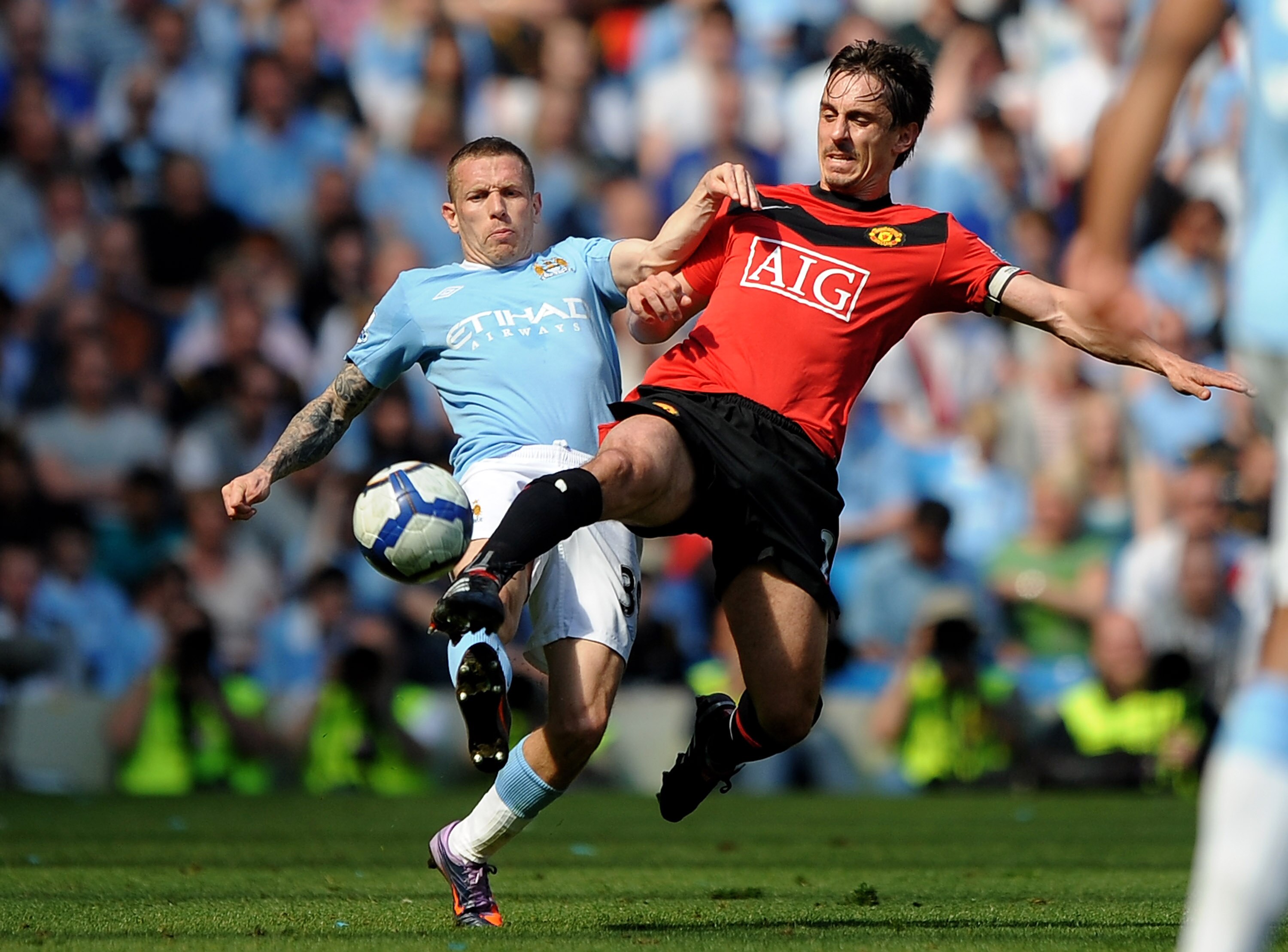 MANCHESTER, UNITED KINGDOM - APRIL 17:  Craig Bellamy of Manchester City competes for the ball with Gary Neville of Manchester United during the Barclays Premier League match between Manchester City and Manchester United at the City of Manchester Stadium