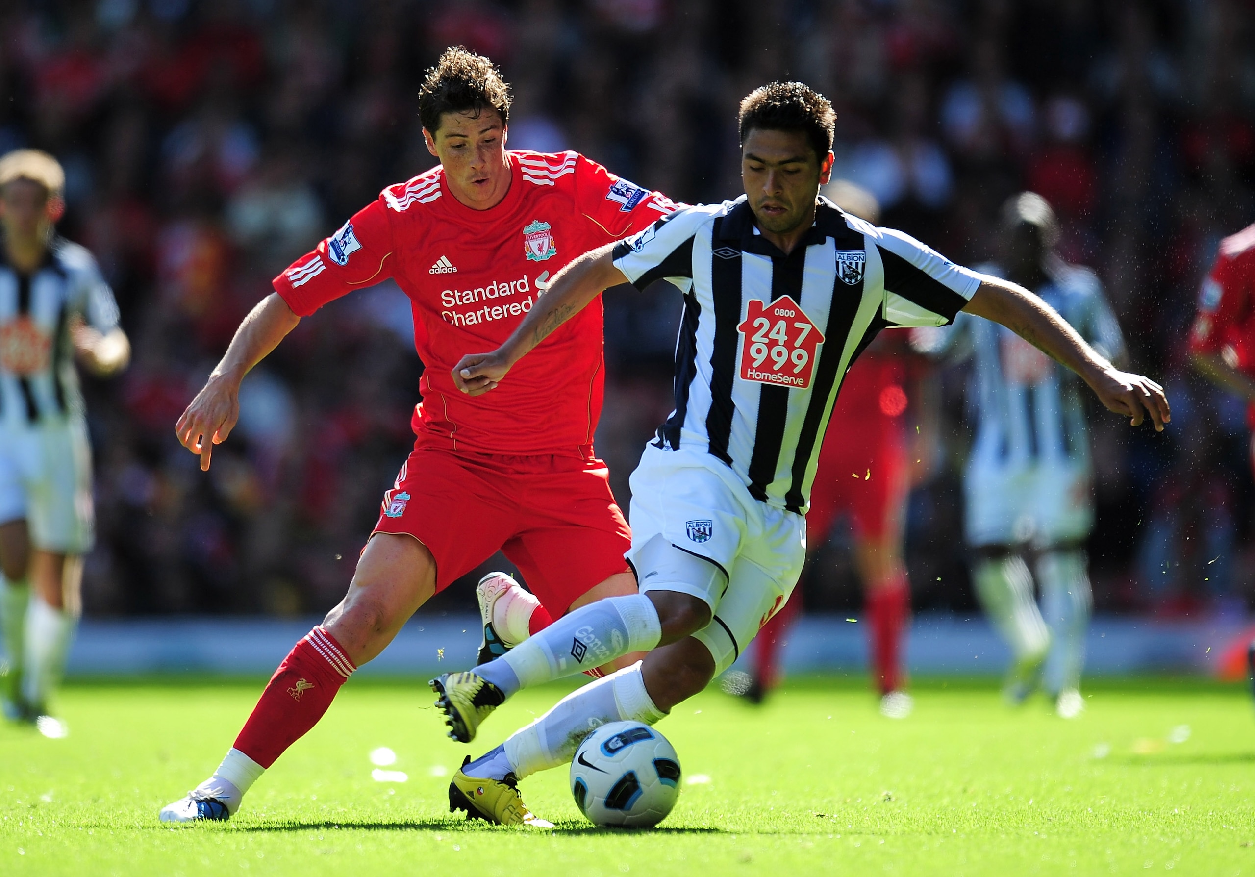 LIVERPOOL, ENGLAND - AUGUST 29:  Fernando Torres of Liverpool competes for the ball with Gonzalo Jara of West Bromwich Albion during the Barclays Premier League match between Liverpool and West Bromwich Albion at Anfield on August 29, 2010 in Liverpool, E